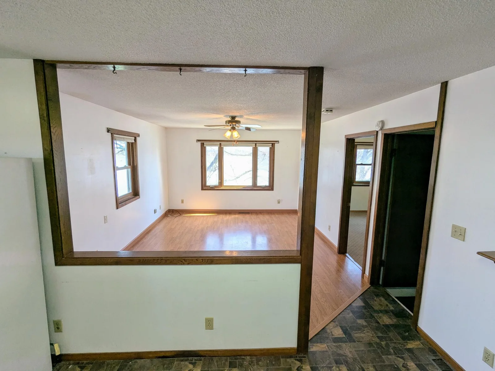View into Living Room (Doorway to Basement Stairs and Primary Bedroom)