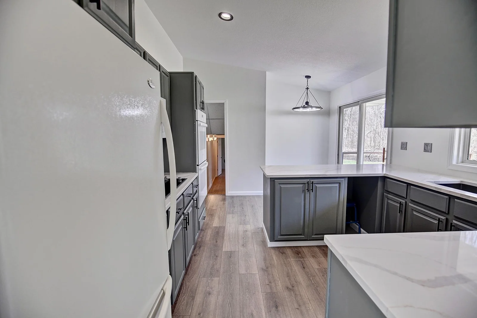 Kitchen with updated flooring, painted cabinets & gorgeous high end countertops!