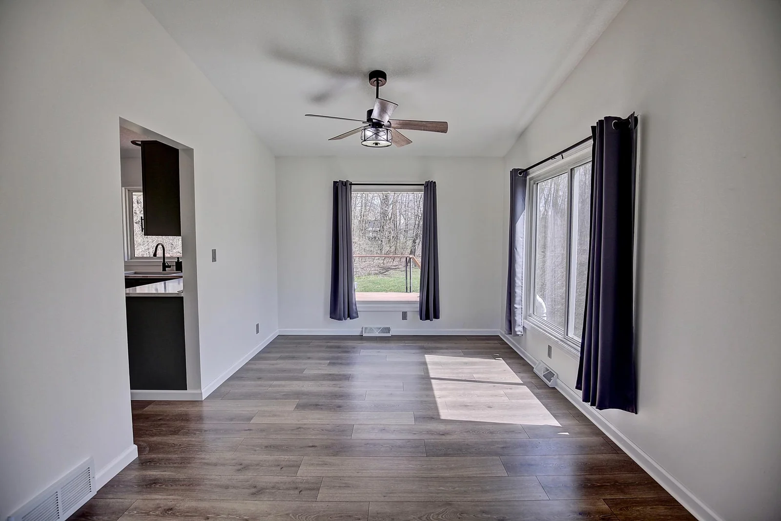 Dining room with updated flooring, paint and windows.