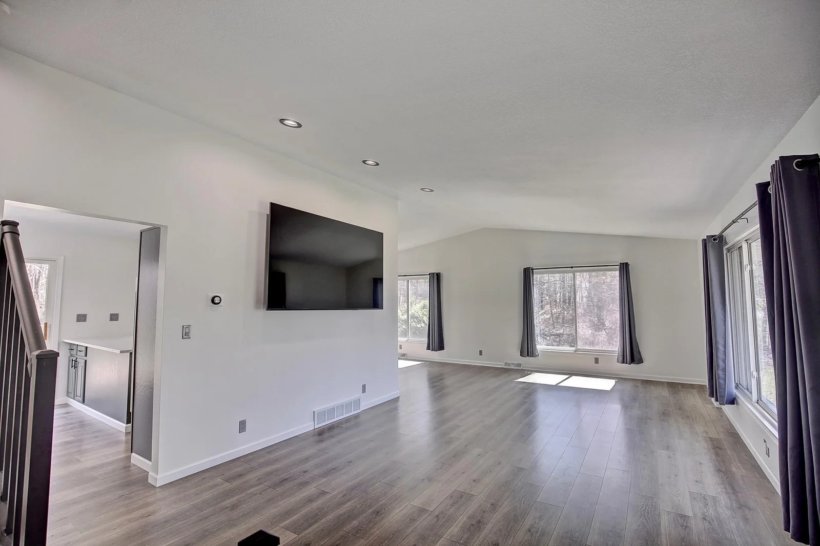 Living Room with updated flooring, trim, paint and windows