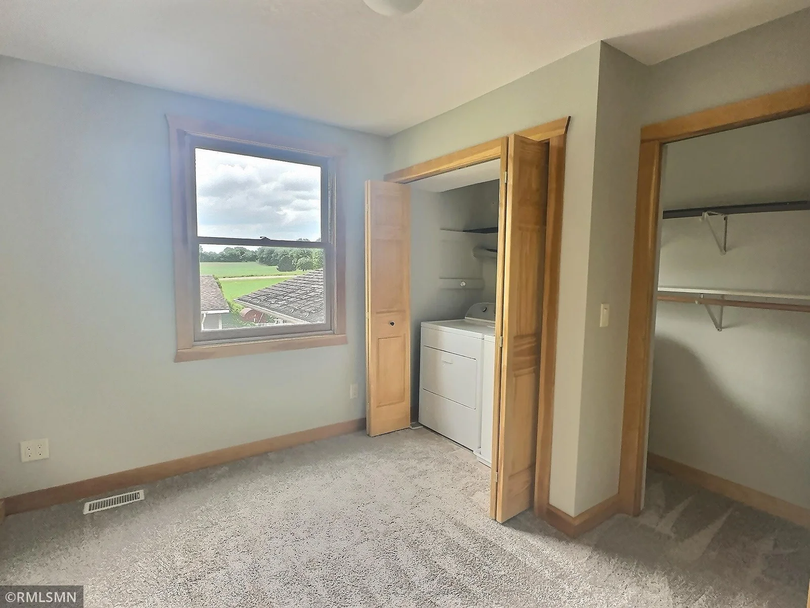 The second upper-level bedroom offers two closets and features fresh paint and new carpeting. The washer and dryer are located in the closet!
