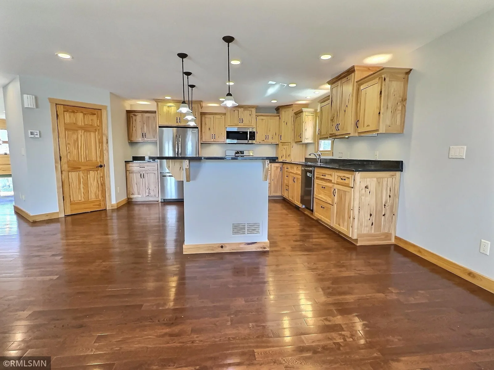 In addition to all the cabinets this kitchen has to offer, the door on the left is a walk in pantry!