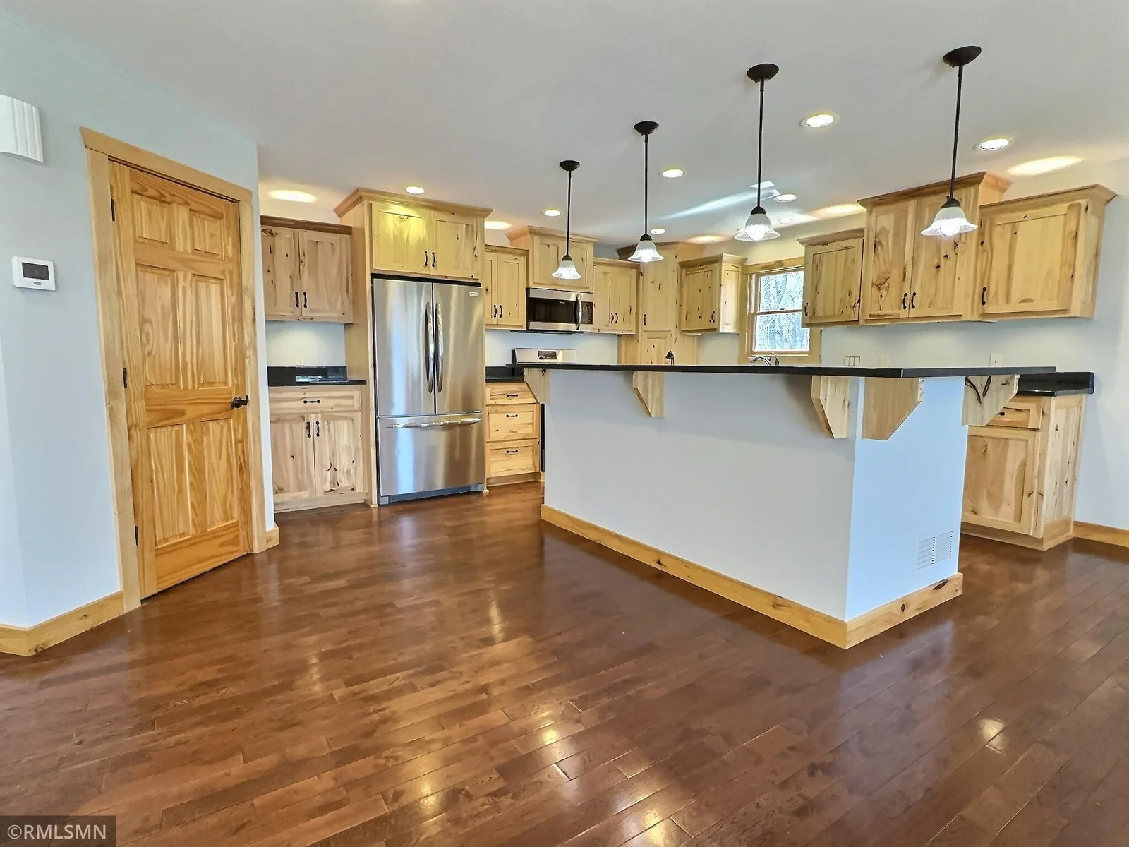 Beautiful hickory cabinetry surrounds this spacious kitchen.  Lots of lighting, including above and under the cabinets, offers a nice atmosphere as well as a bright working space.