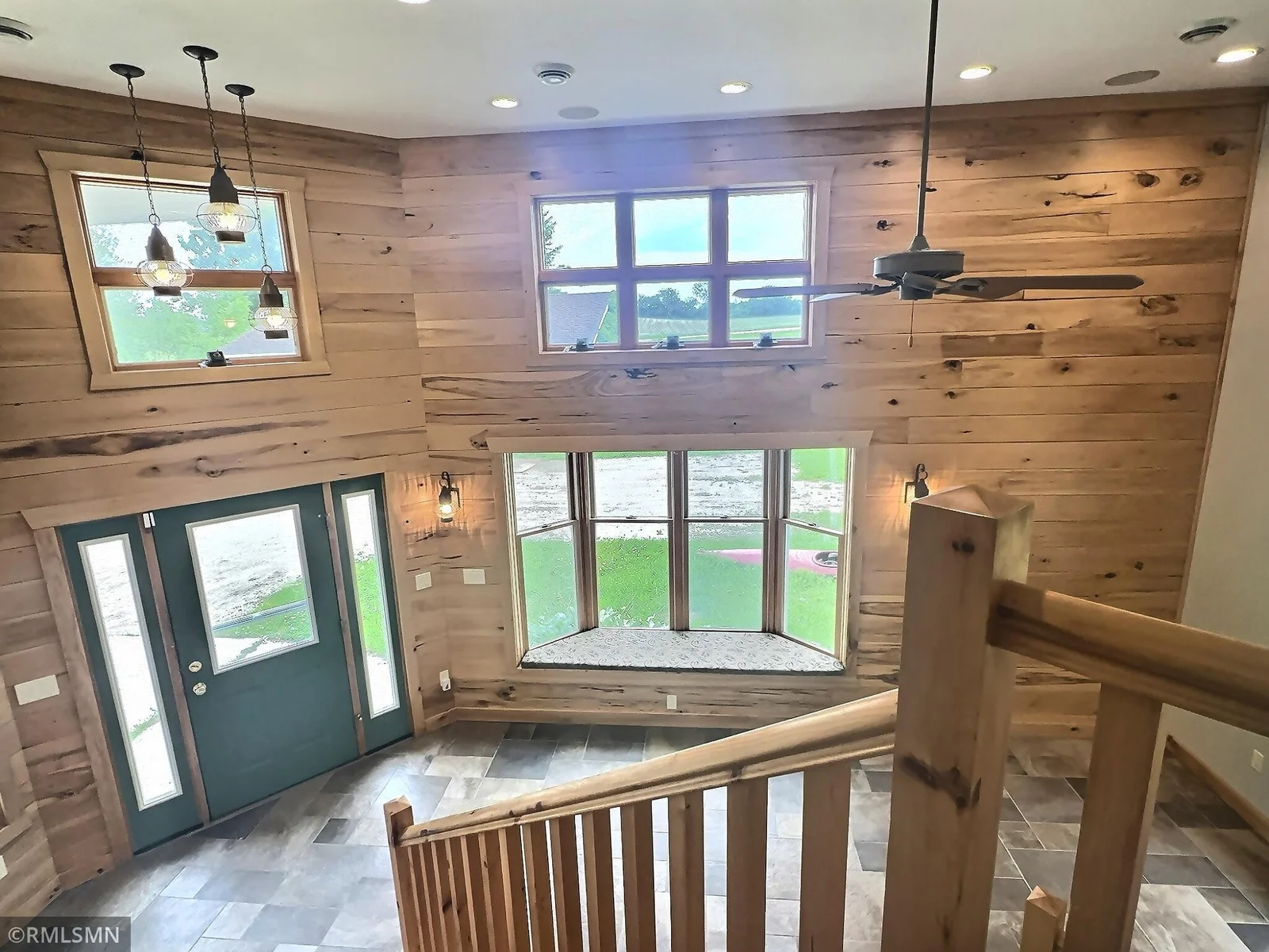 A view from the top of the stairs shows off the beautiful tongue and groove and natural light from all the windows. Enjoy a book and a cup of coffee while relaxing in the window seat, enjoying the morning sunshine.