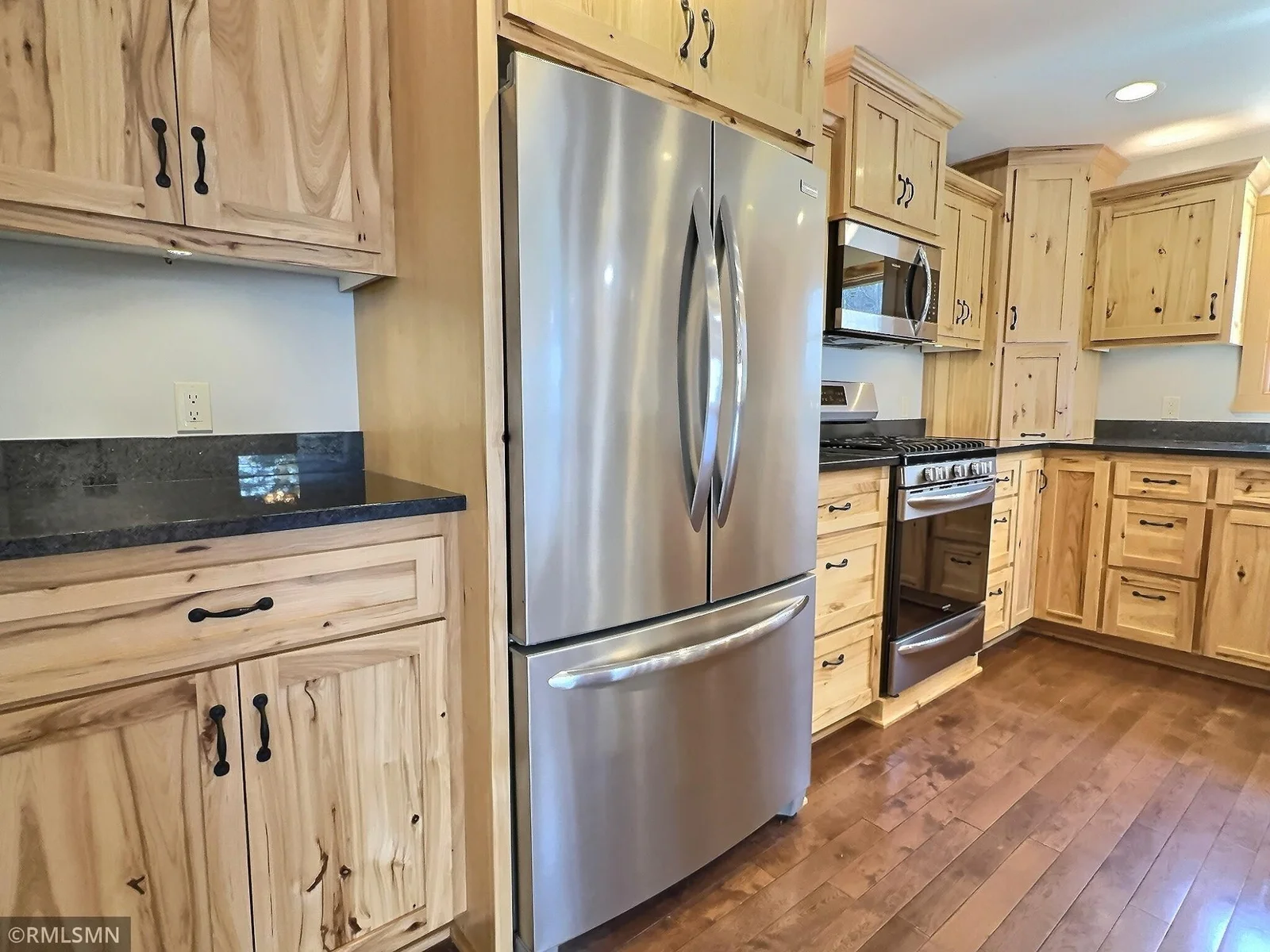 Black granite counter tops are a nice contrast to the hickory and stainless appliances. There is plenty of room for storage for all your cooking and baking needs.