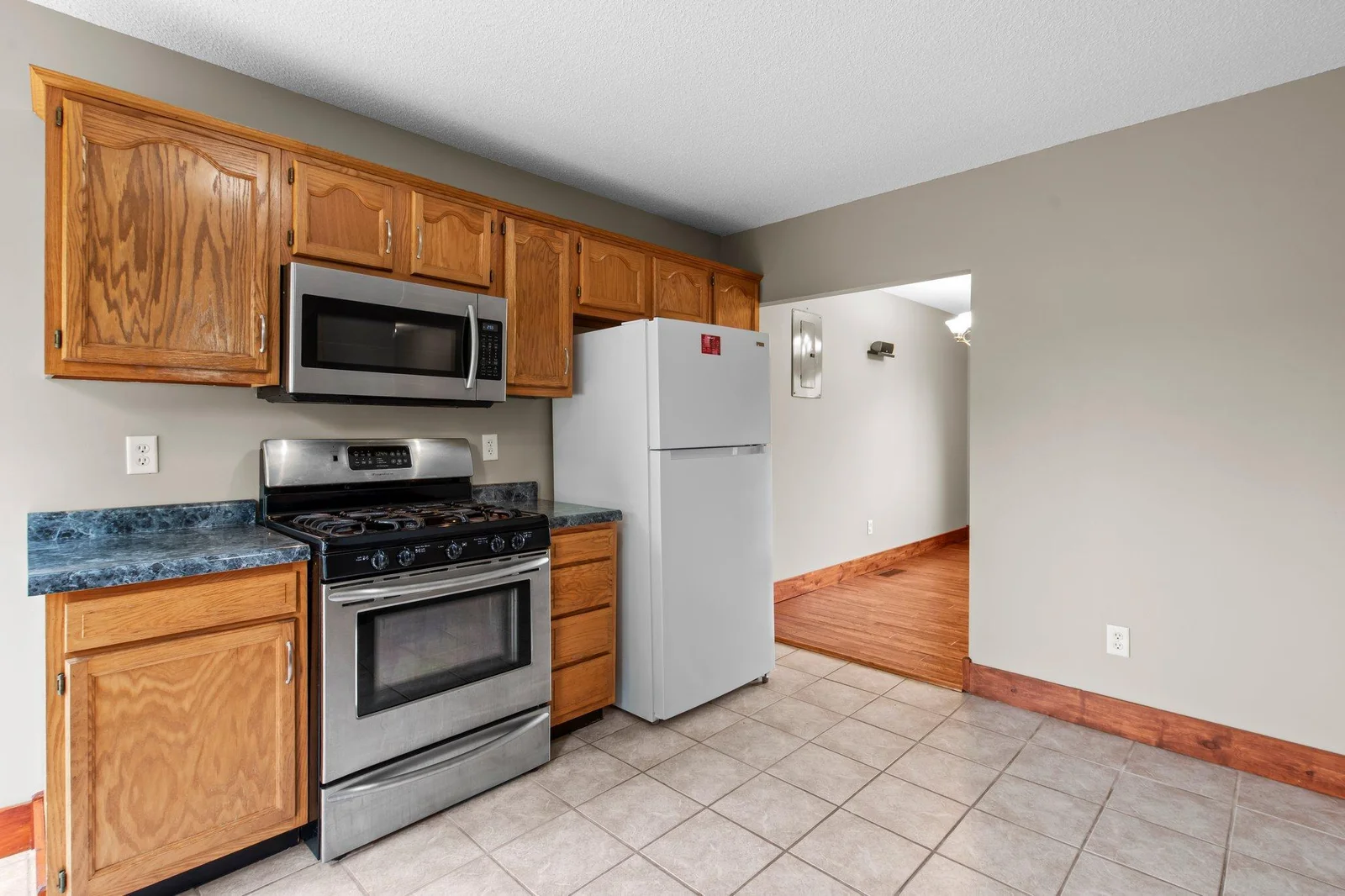 The kitchen includes tiled floors and lots of cabinet space.