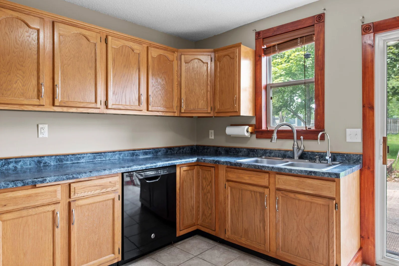 The kitchen includes tiled floors and lots of cabinet space.