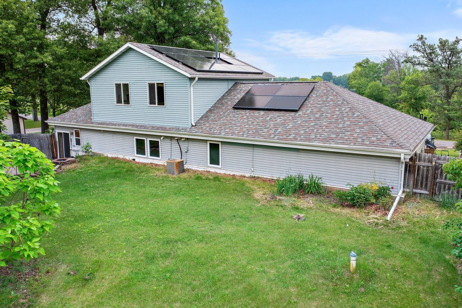 This property includes a fenced-in backyard and solar panels on the roof.