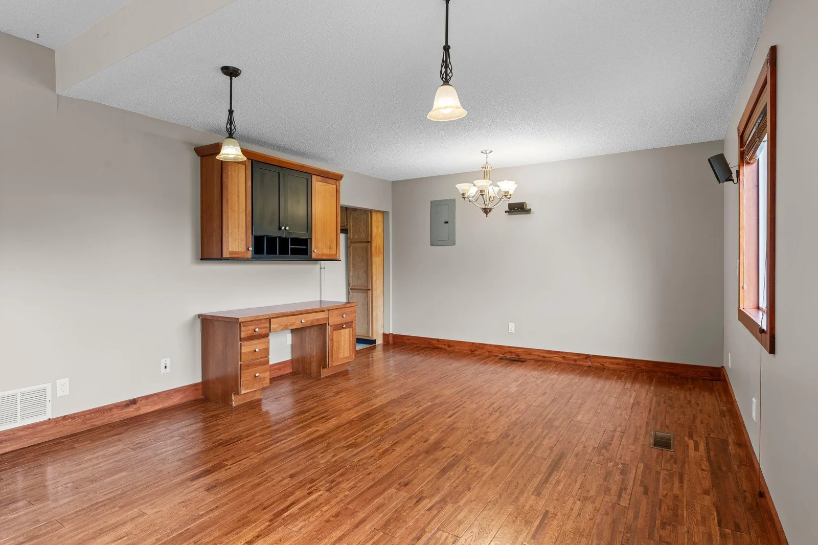 The living room and dining area include beautiful natural woodwork.