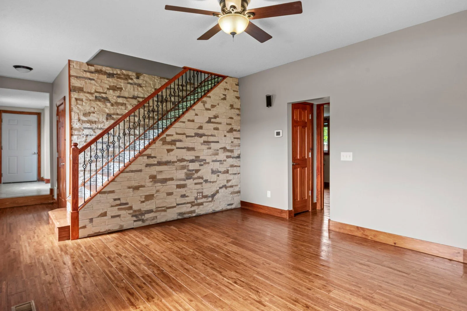 The staircase to the upper level includes beautiful stone and mosaic tile.