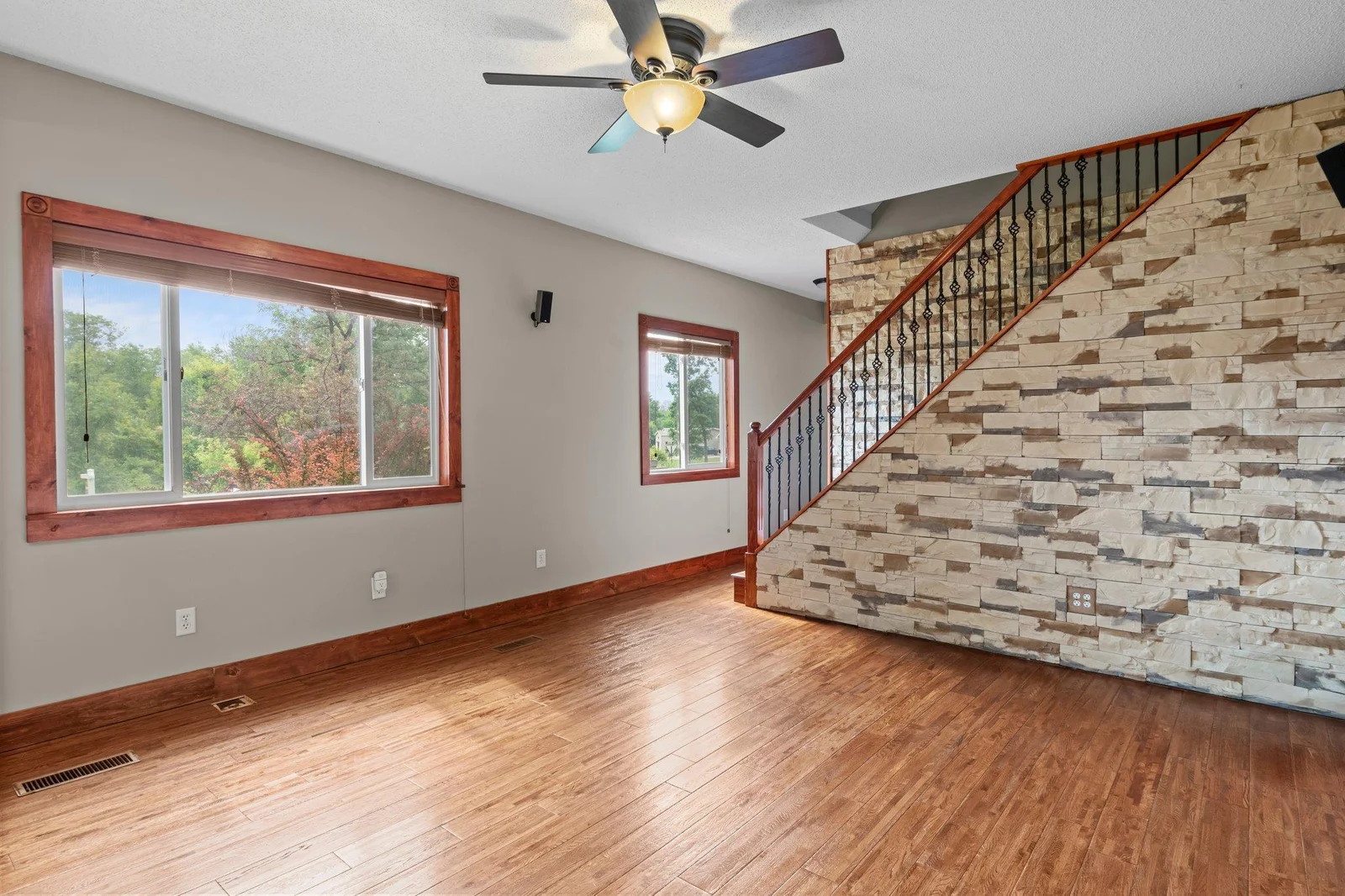 The living room has beautiful hardwood floors and access to the upper level.