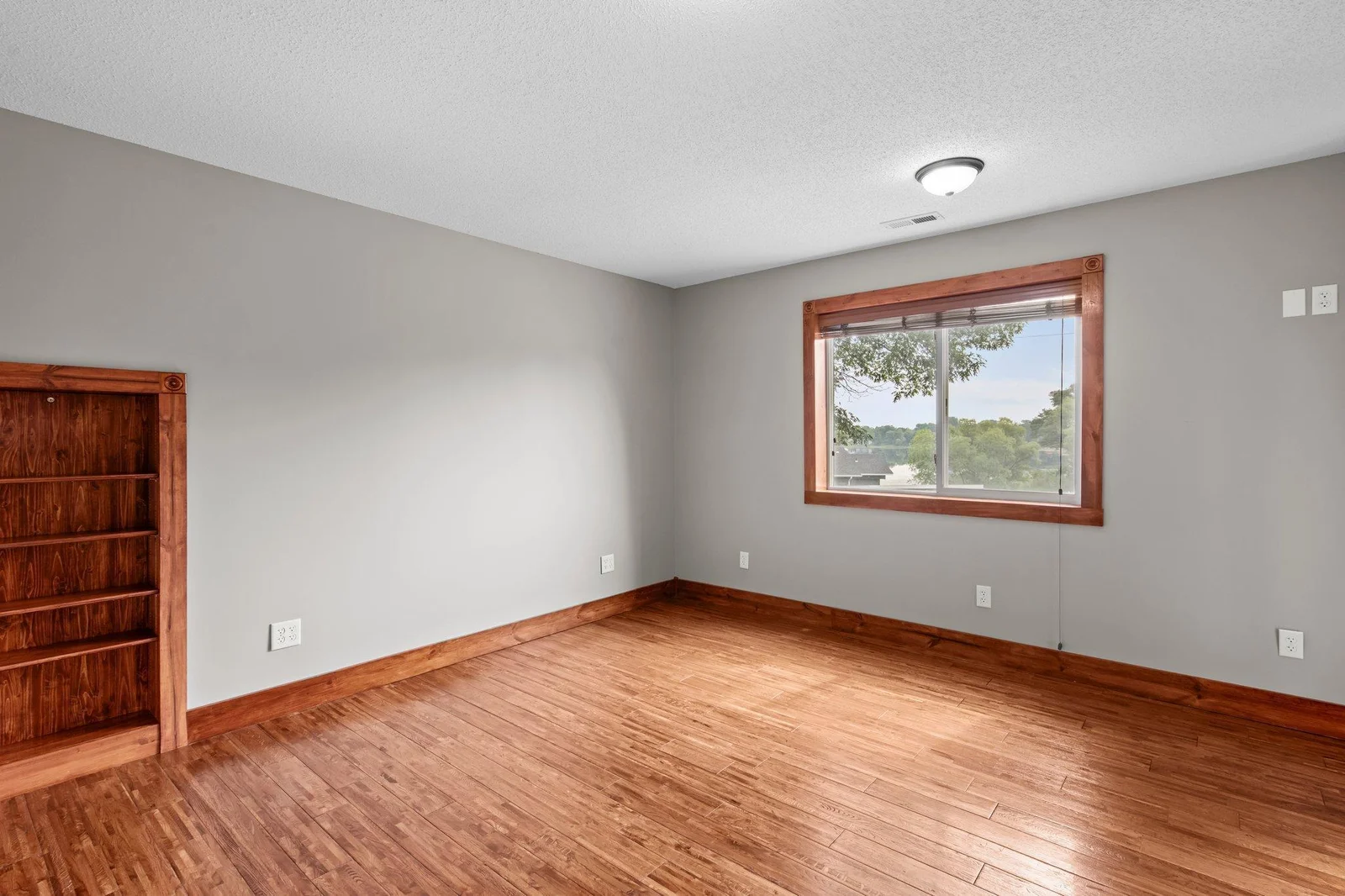 The primary bedroom on the upper level includes hardwood floors and a large walk-in closet.