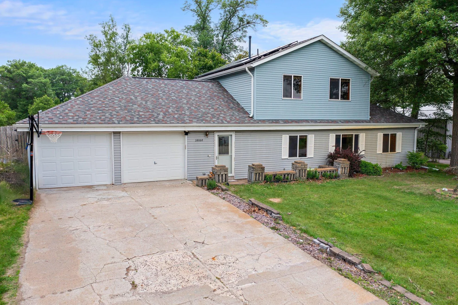 This property sits on nearly a half-acre lot with multiple mature trees and a fenced-in backyard.
