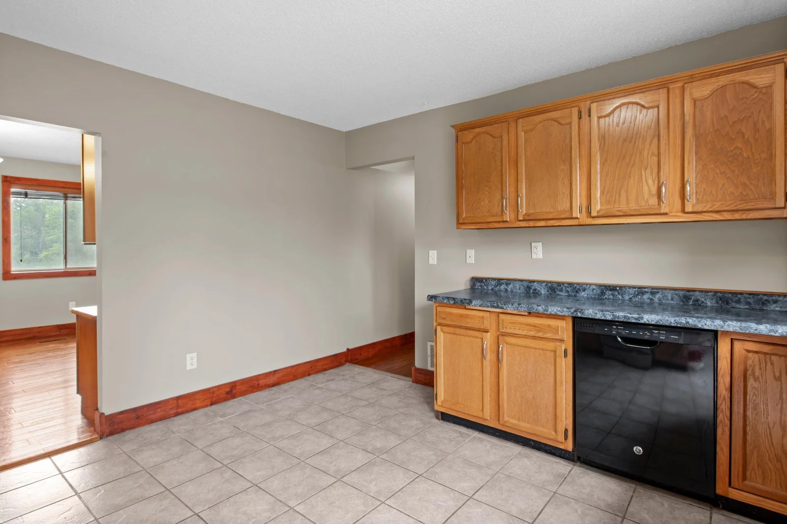 The kitchen includes tiled floors and lots of cabinet space.