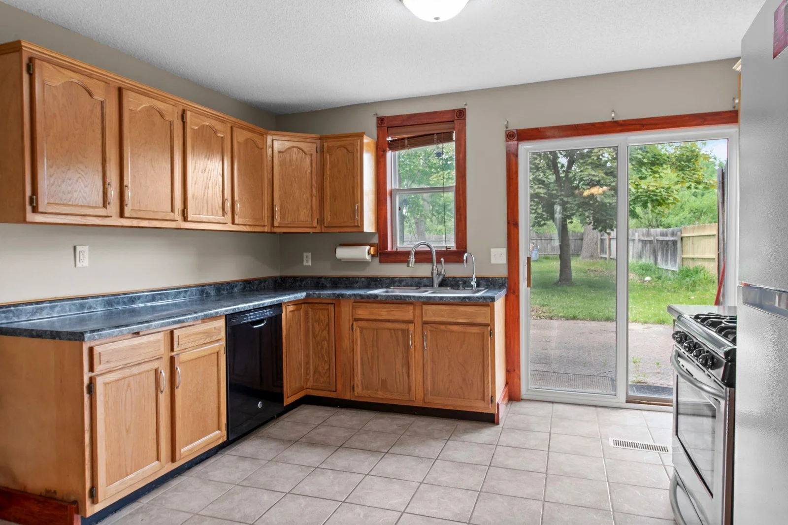 The kitchen includes tiled floors and lots of cabinet space.