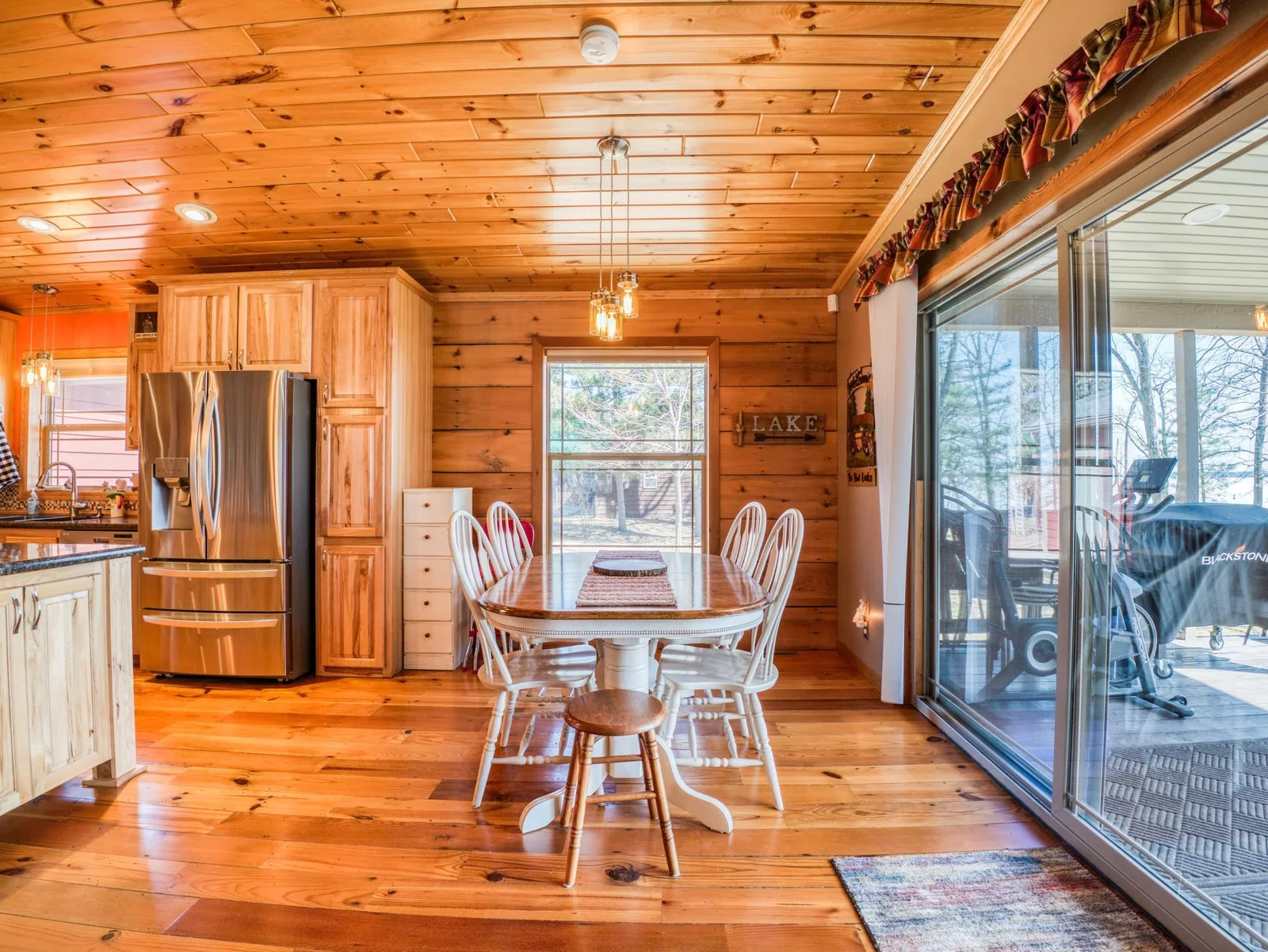 Dining room just off of the kitchen, patio doors leading to the covered porch.