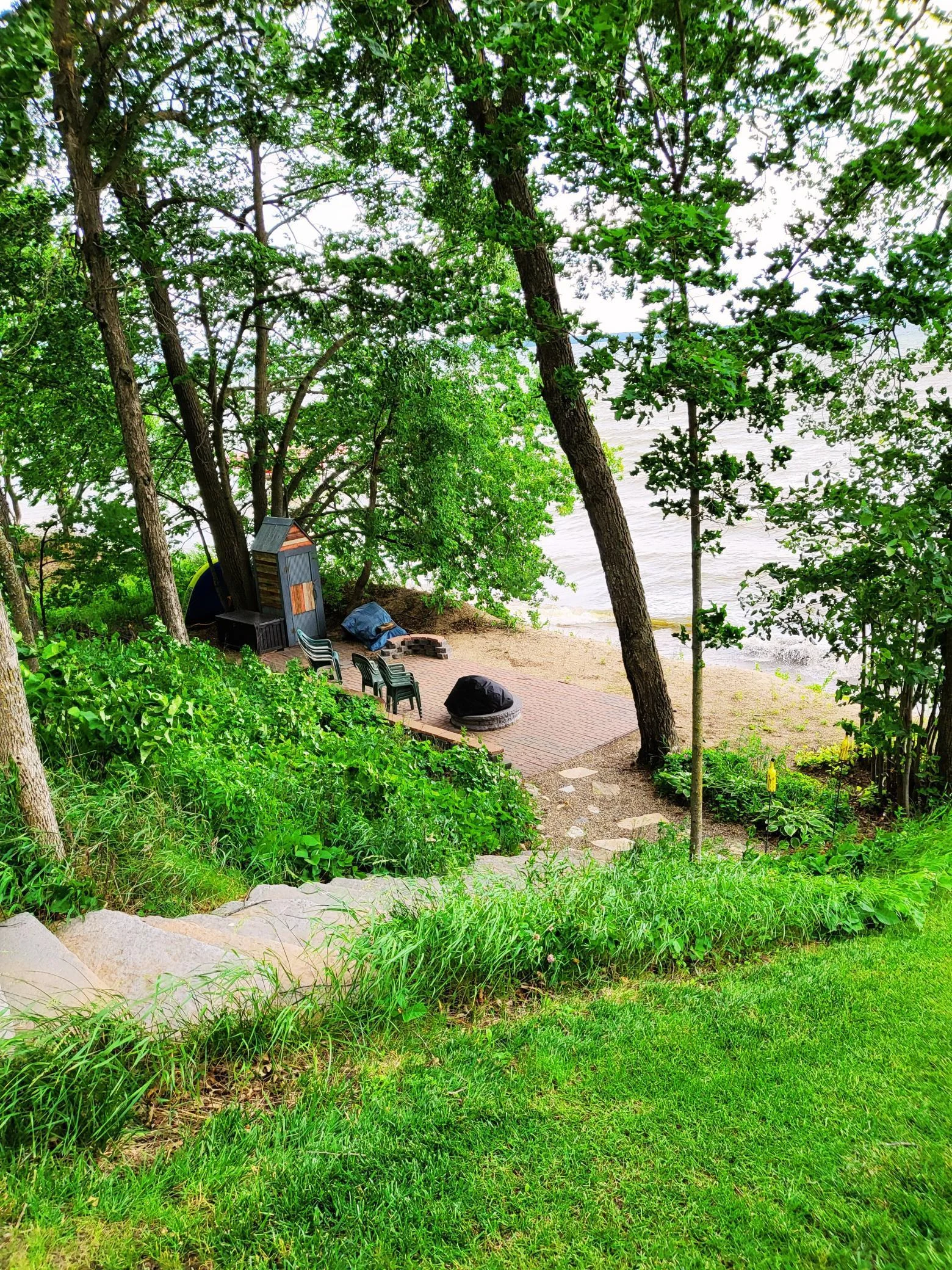 Check out the sandy shoreline complete with a patio and firepit