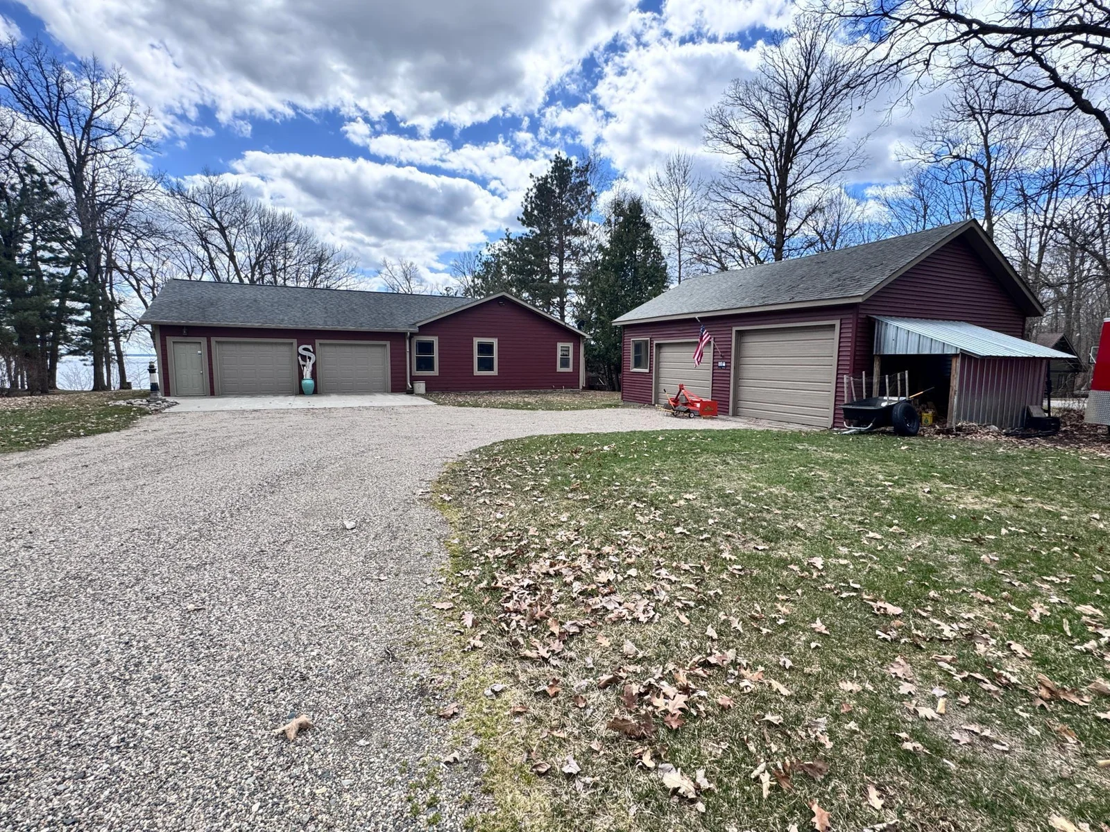 Pulling in to the driveway you will be greeted by the single level home, double detached garage and peeking from the back of the home is the lake.