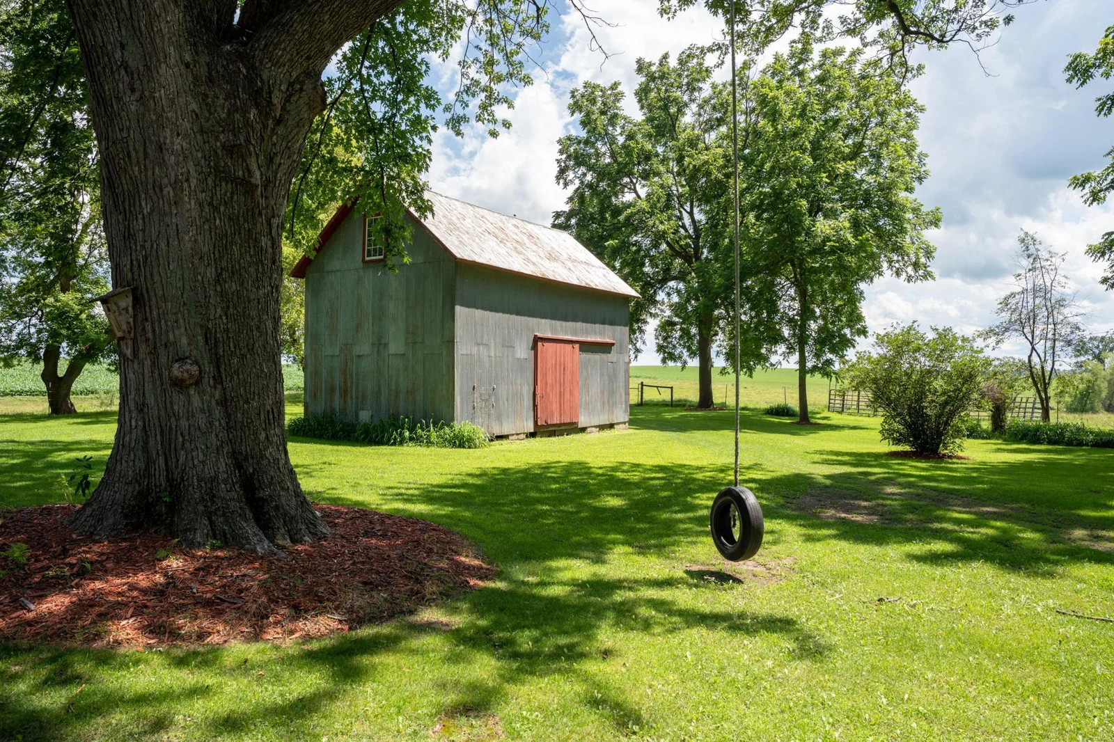 The vintage granary adds creative potential for a guest cabin, art studio, or playhouse.