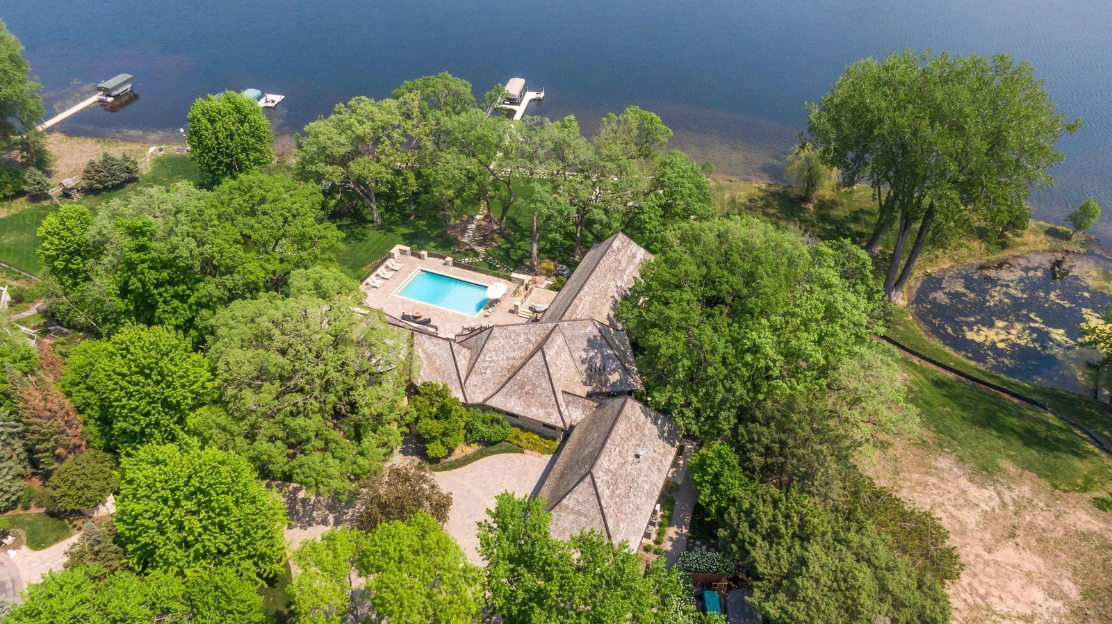 Heavily wooded lot, dock, boat house and 185' shoreline on Bryant Lake