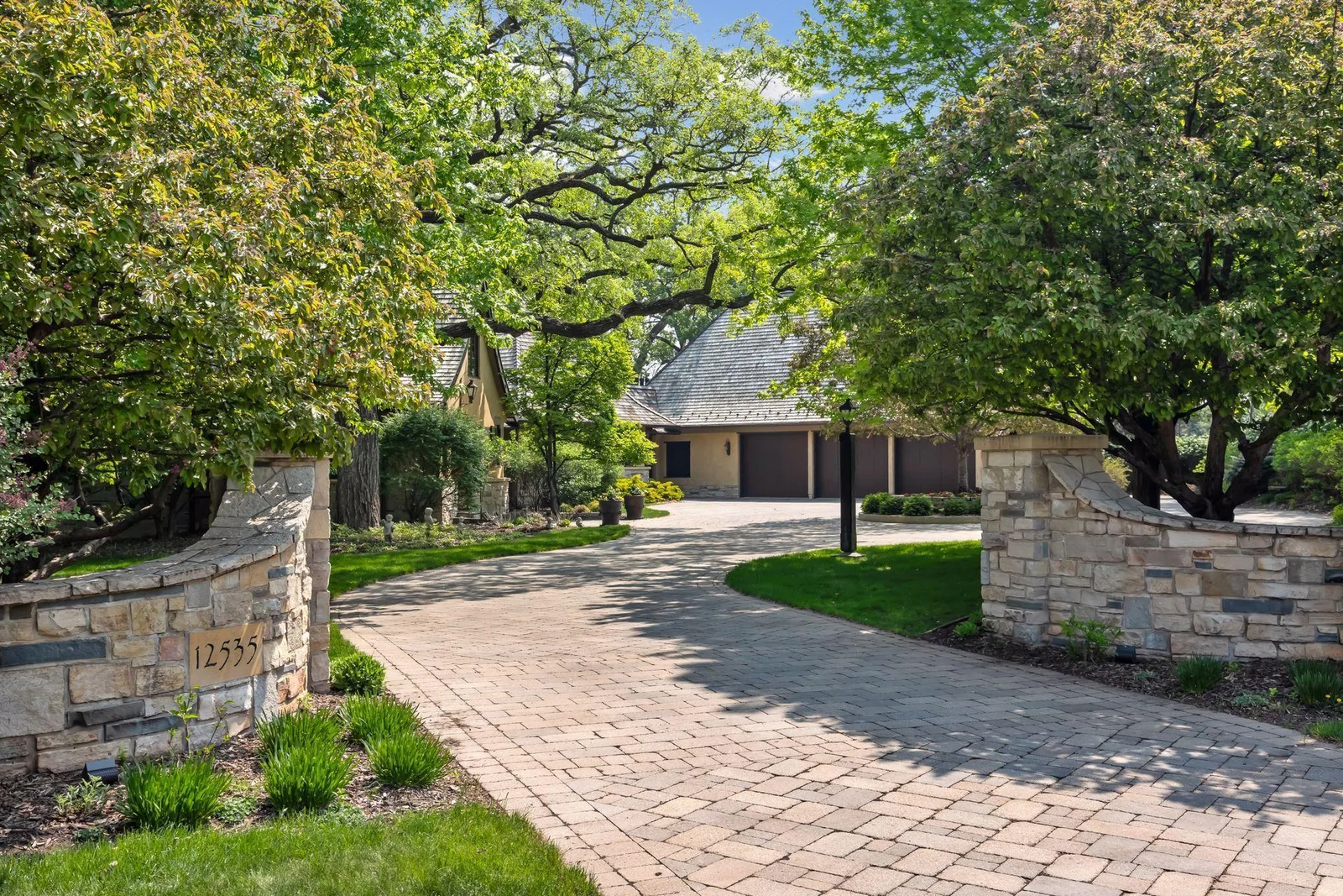 Enjoy a private entrance and home tucked off the cul-de-sac location; paver driveway is heated