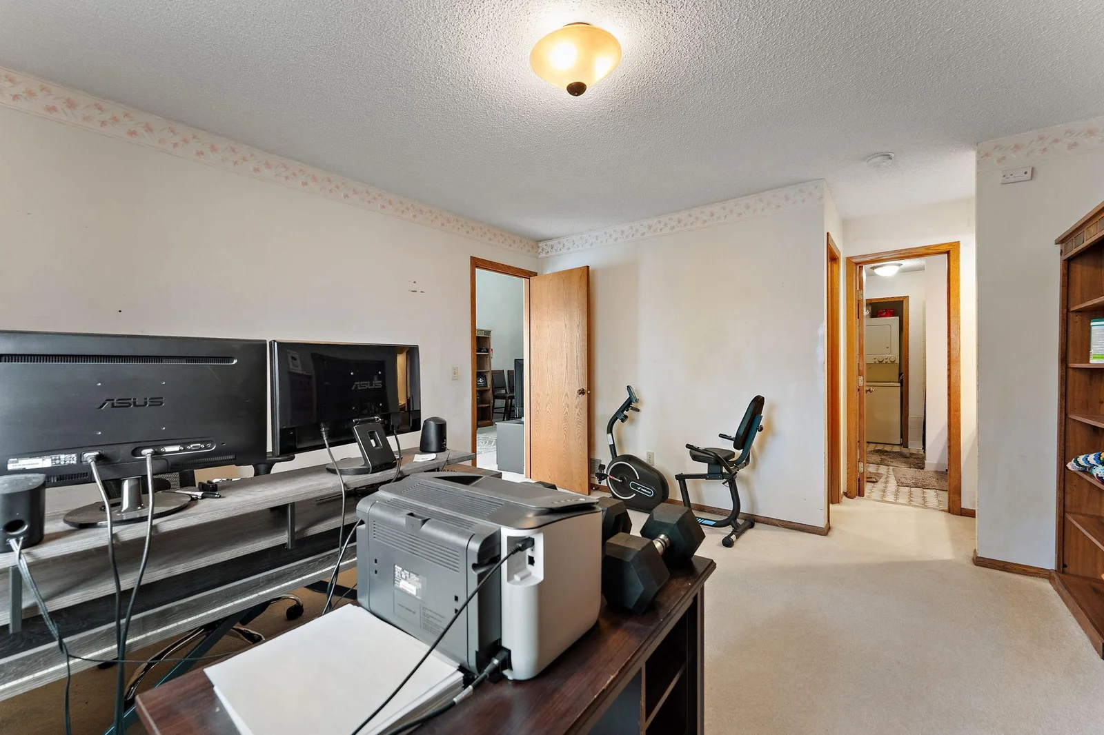 Larger bedroom/BR1 with view of walk-thru bath access, stackable W/D, and walk-in closet