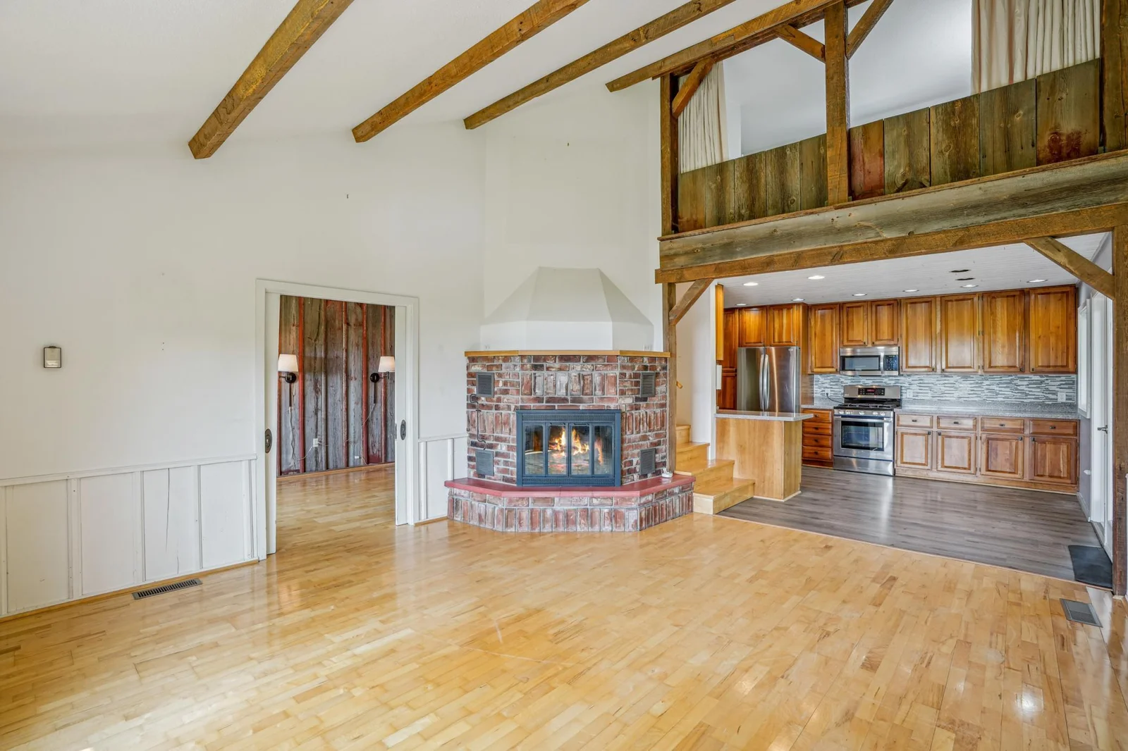 Living room features a bricked wood burning fireplace.