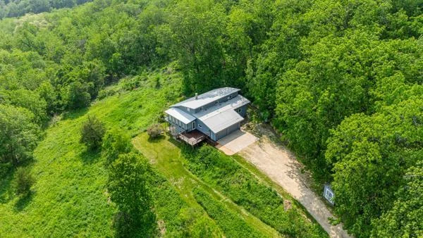 Another aerial view showing the lush foliage surrounding the home.