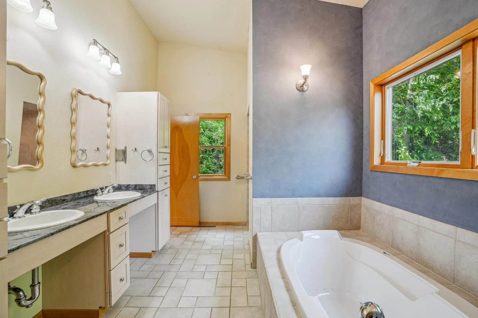 Master suite bath has ceramic floors, a handicap accessible shower, and a whirlpool soaking tub.  Also, note the double vanity. The laundry is included.