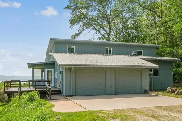 Exterior features include an attached heated garage, a large deck, and a smaller deck.