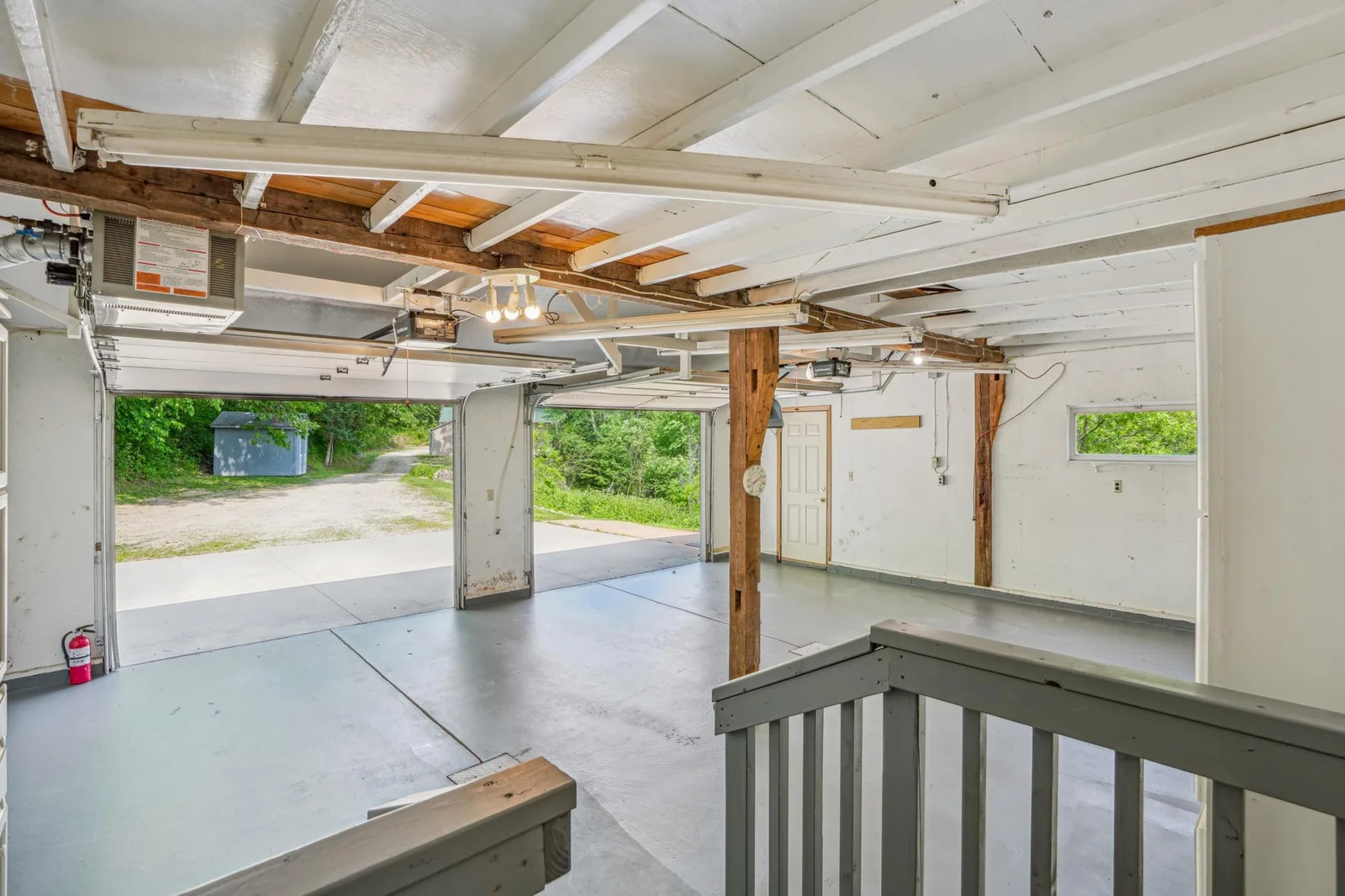This attached lined and heated double garage includes lots of cabinetry.