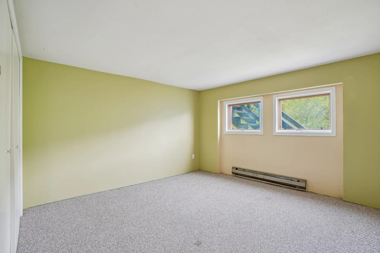 Lower level carpeted bedroom.