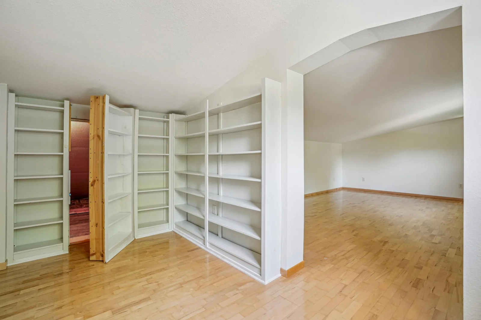 Next to the upper level family room is a large library with lots of book shelves and a "hidden" storage room.