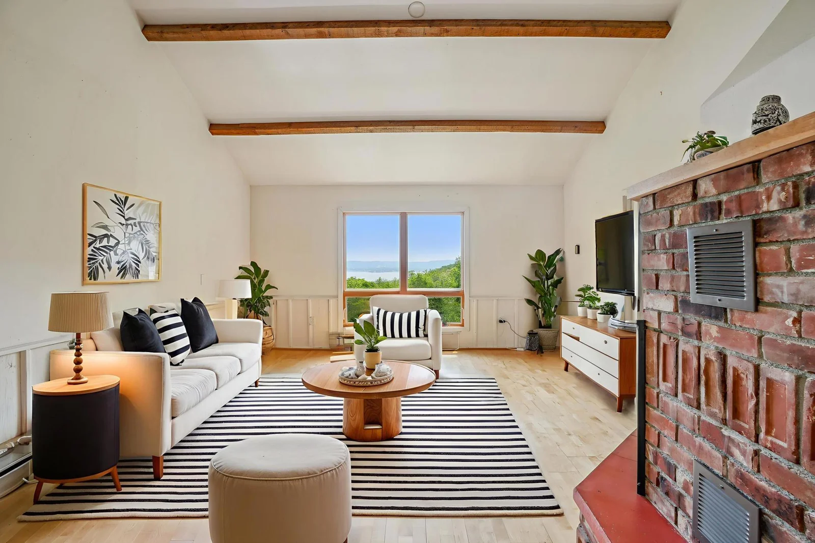The virtually staged living room. The view of the woods and Lake is real.