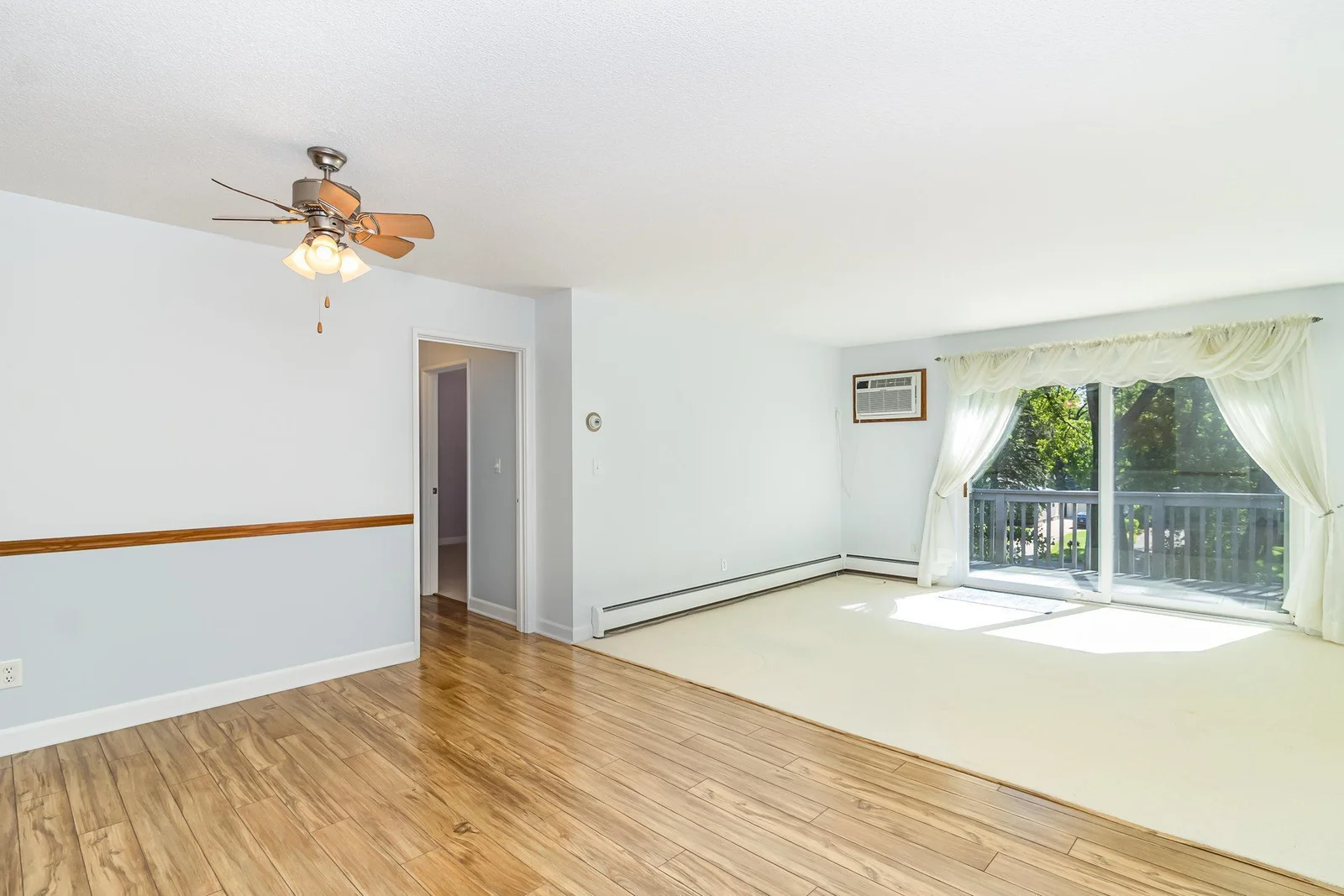 Living room/dining area with a wall-unit air conditioner