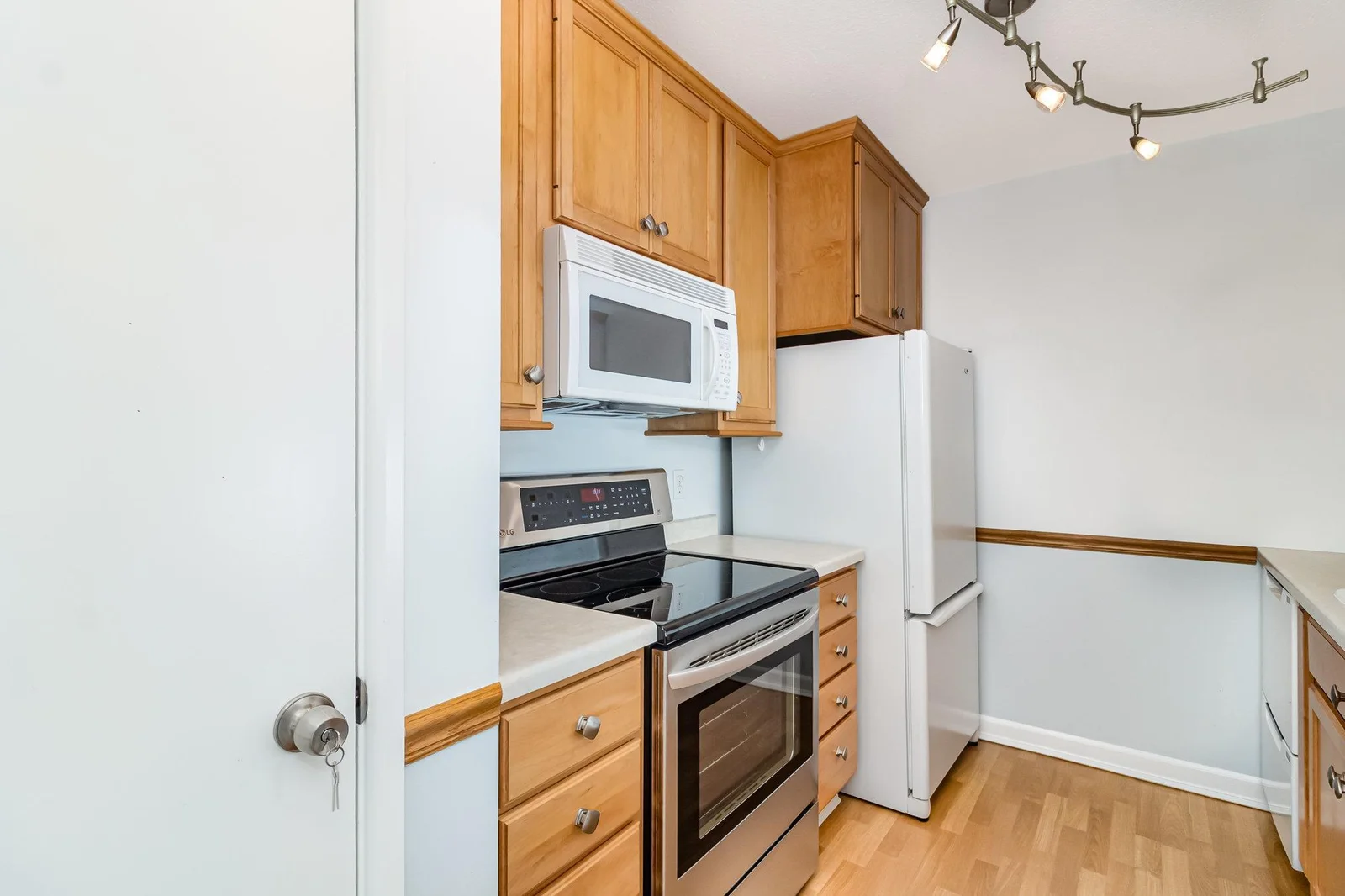 Kitchen has lovely cabinetry and hardware with extra storage provided by a pantry and nearby entry closet
