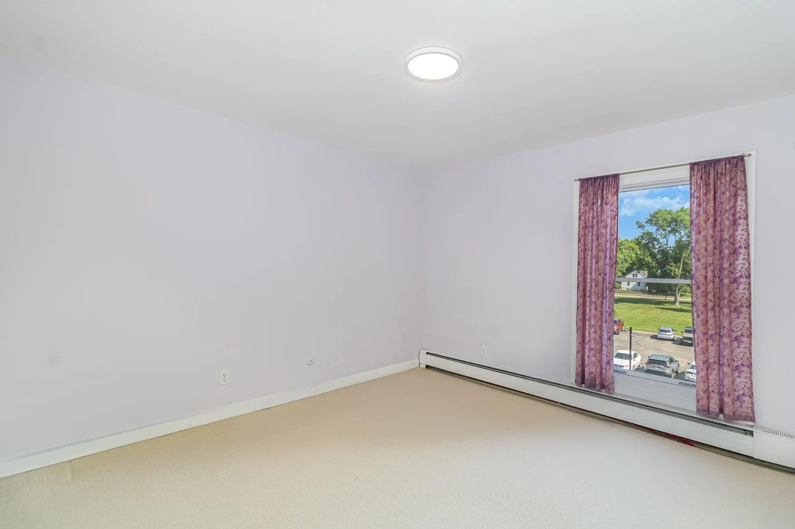 The second bedroom features a large window