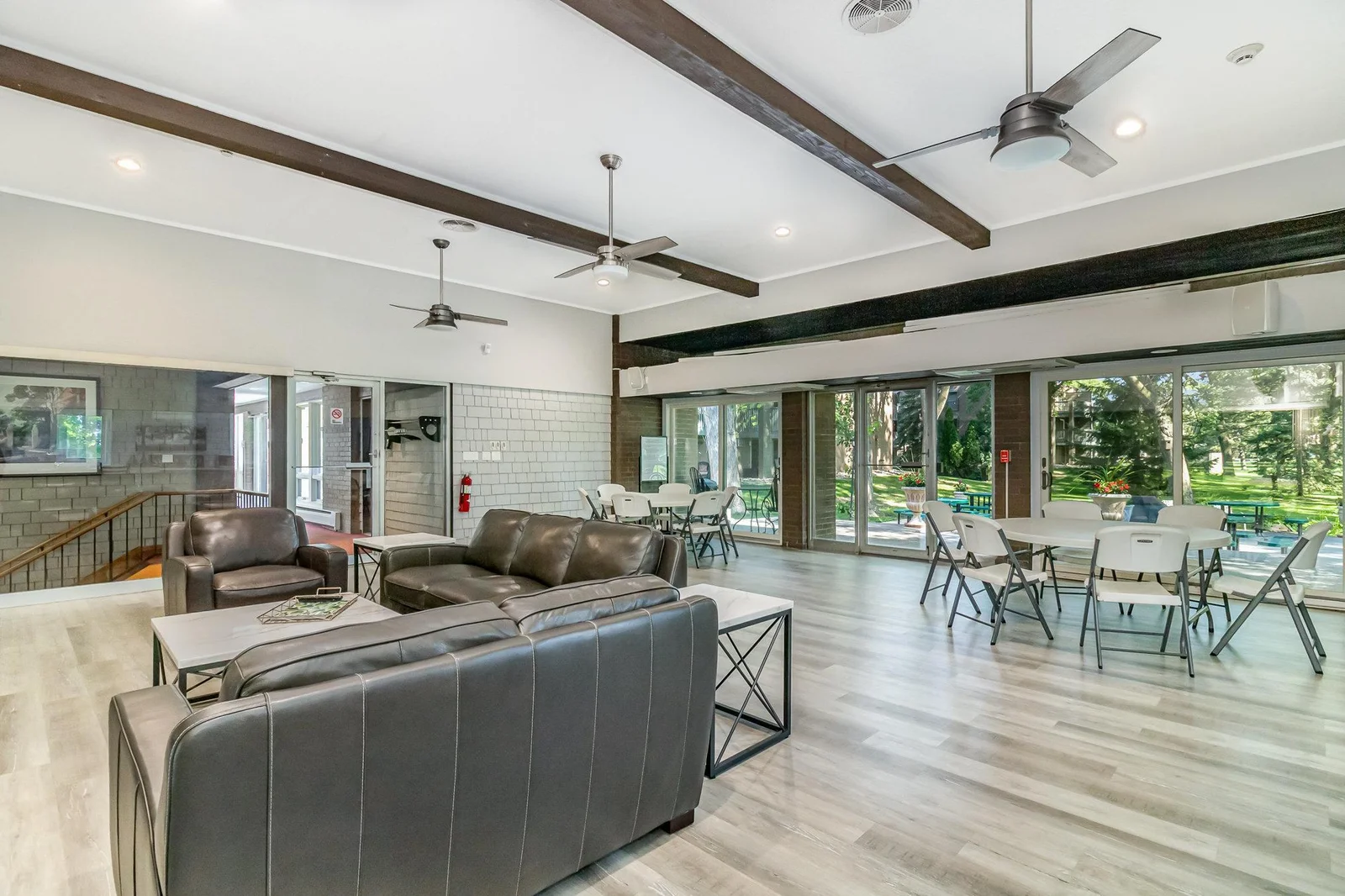 The party room opens to a lovely outdoor space and patio with grills.