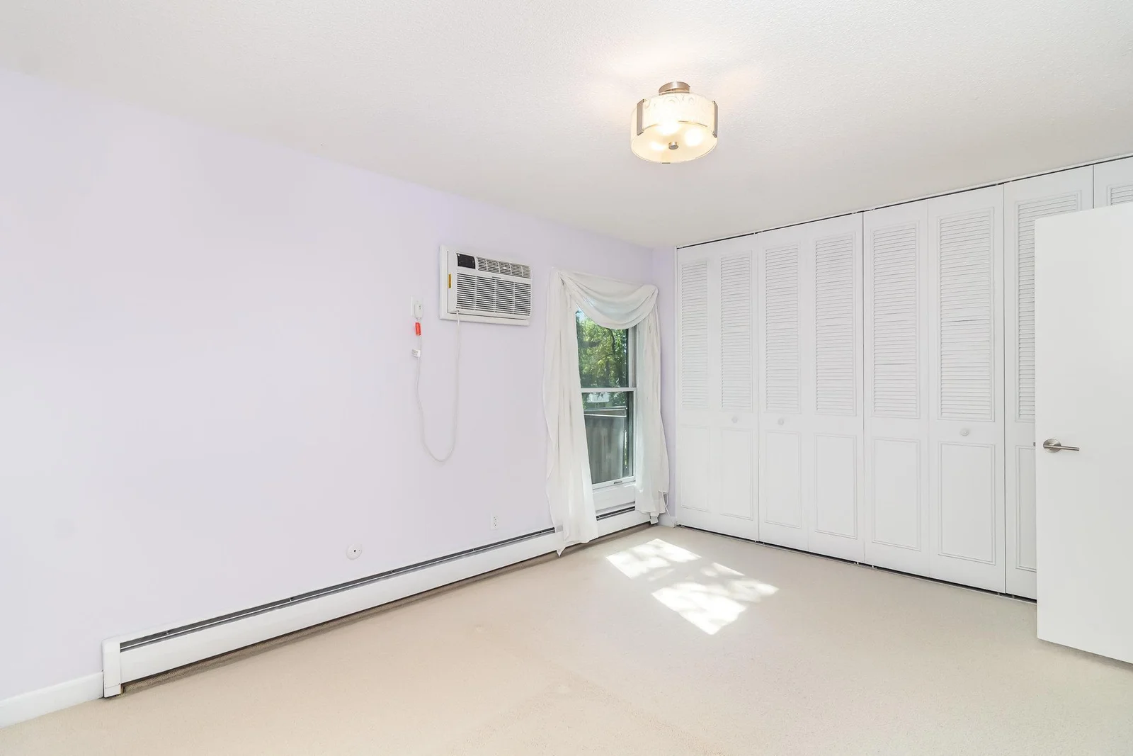 An entire wall of floor-to-ceiling closets provides plenty of storage space
