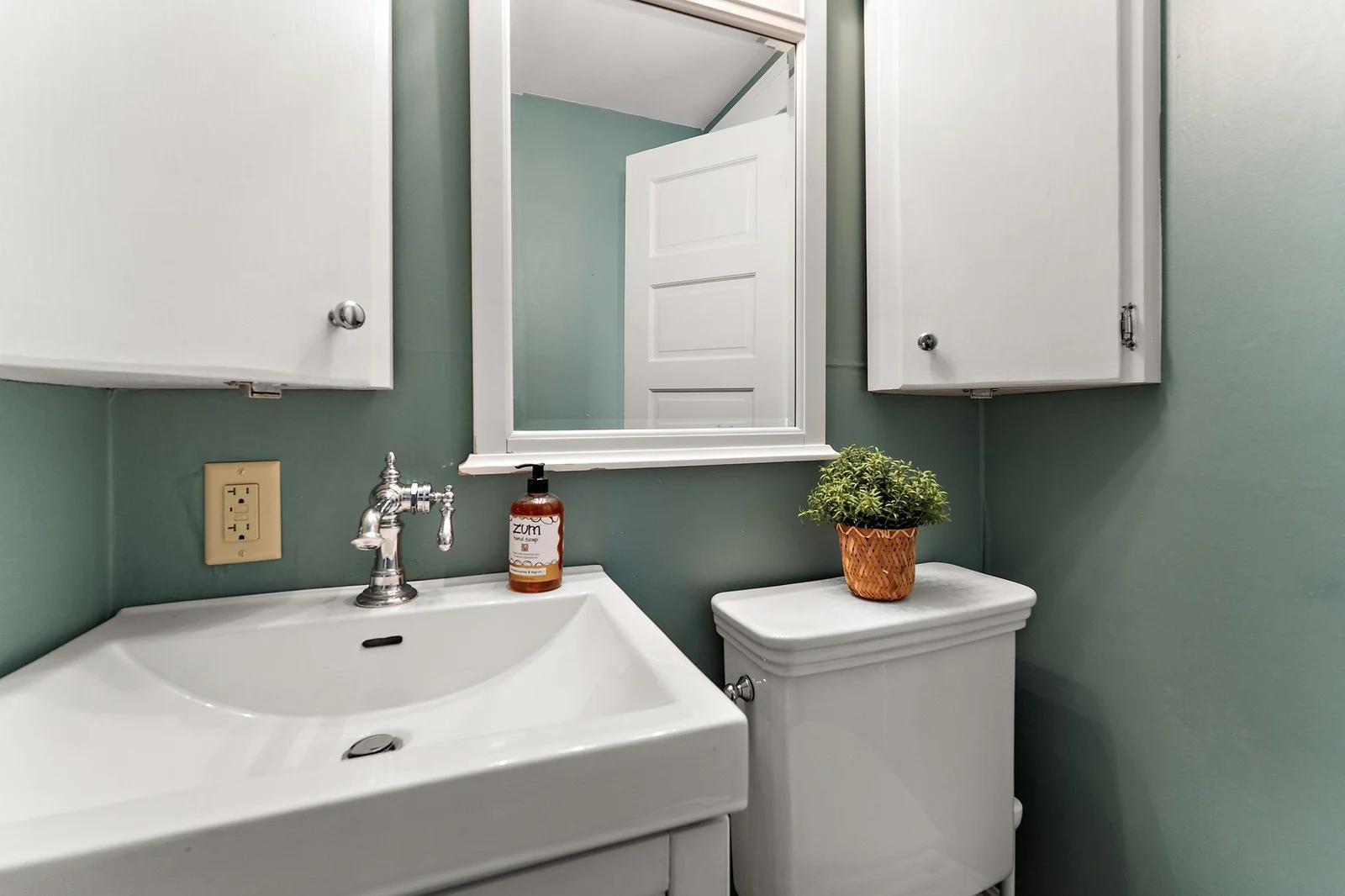 Clean updated half bath near rear door of main level.