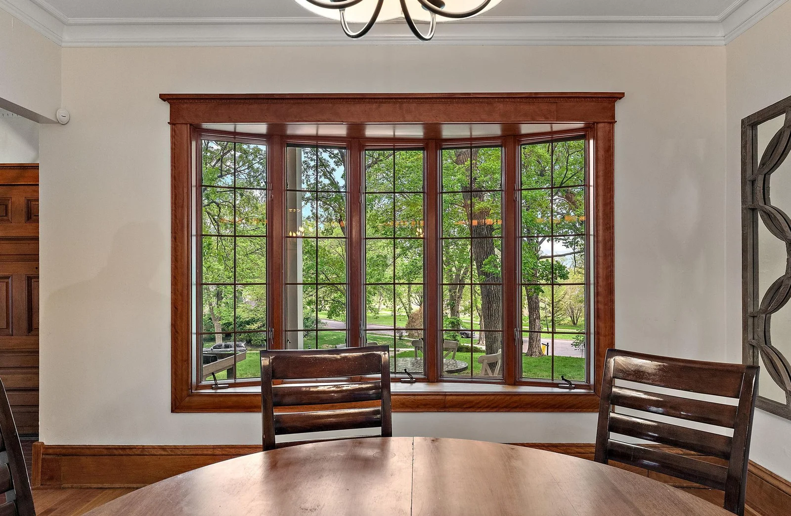 The front of the home features massive casement windows overlooking Nokomis.
