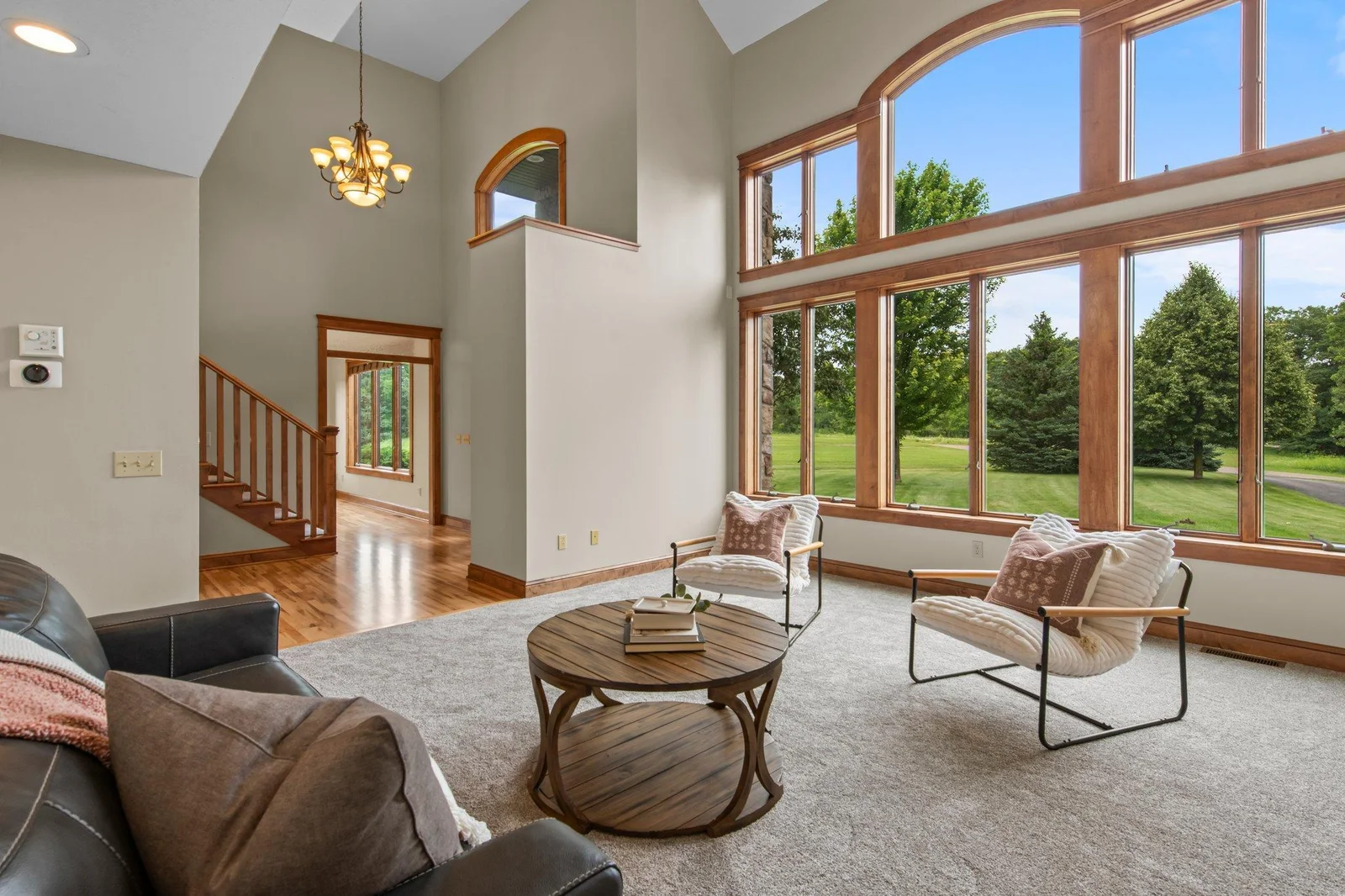 The living room features massive windows that allow lots of natural light in.