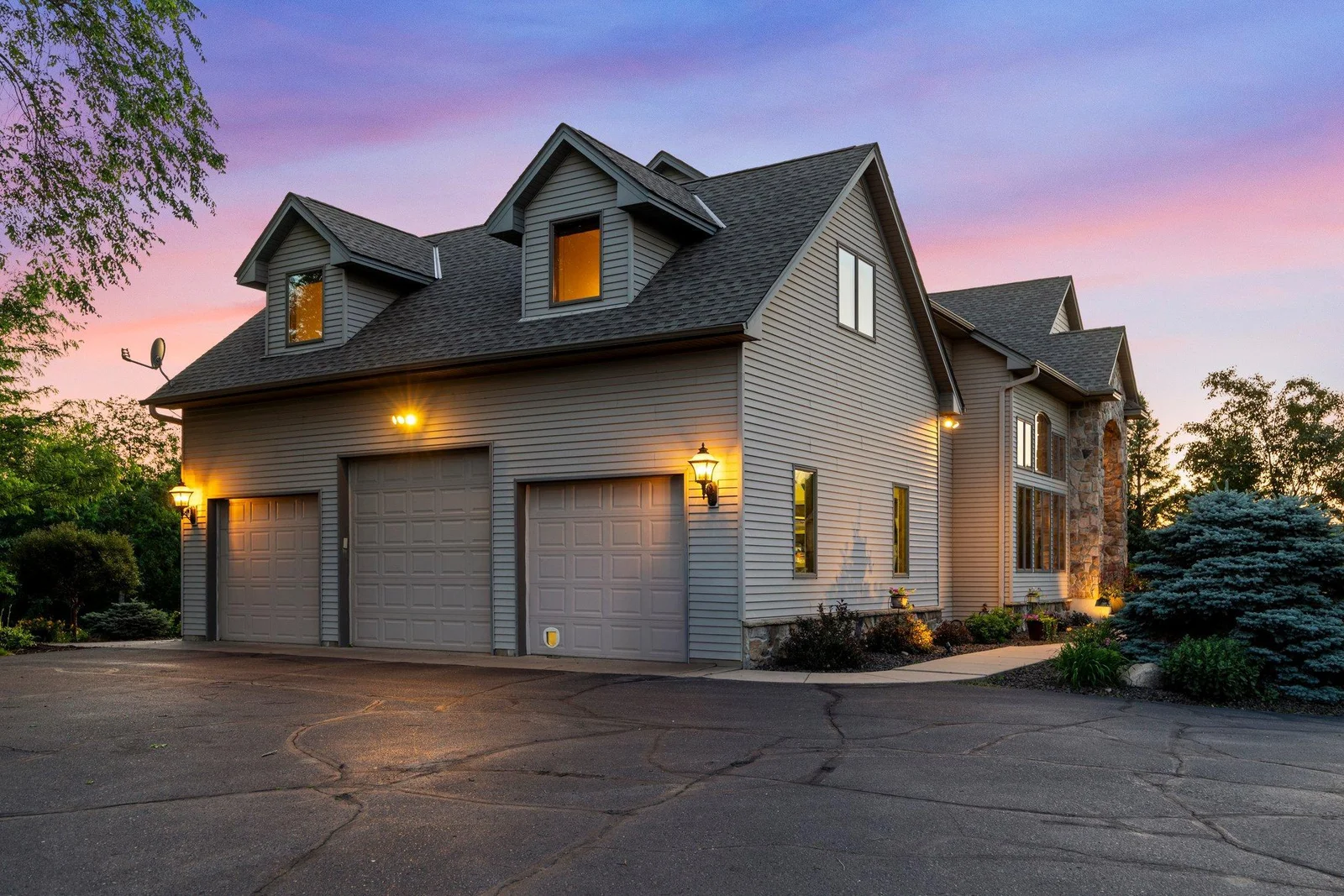 This home features an asphault driveway and an attached heated and insulated 3-car garage.