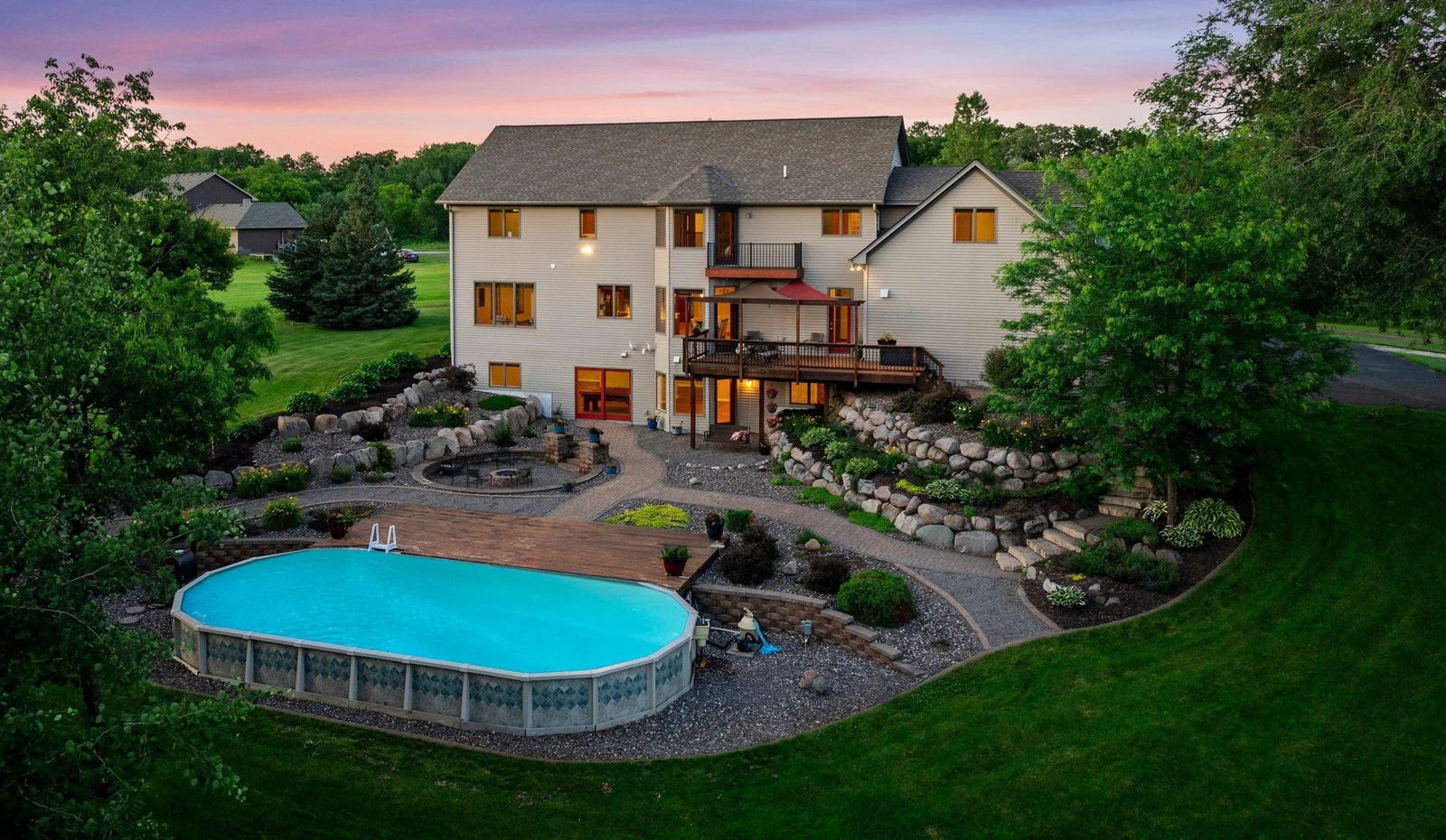 The backyard is an oasis, featuring stunning landscaping and a pool.