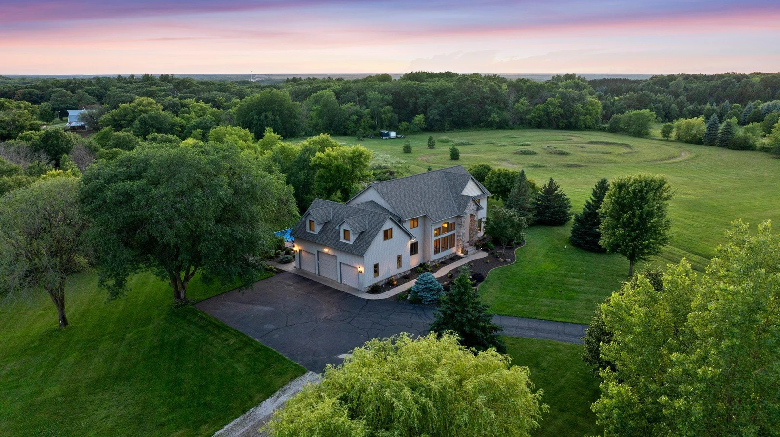 This gorgeous estate sits on 15 secluded acres and includes a pool and a pole building.