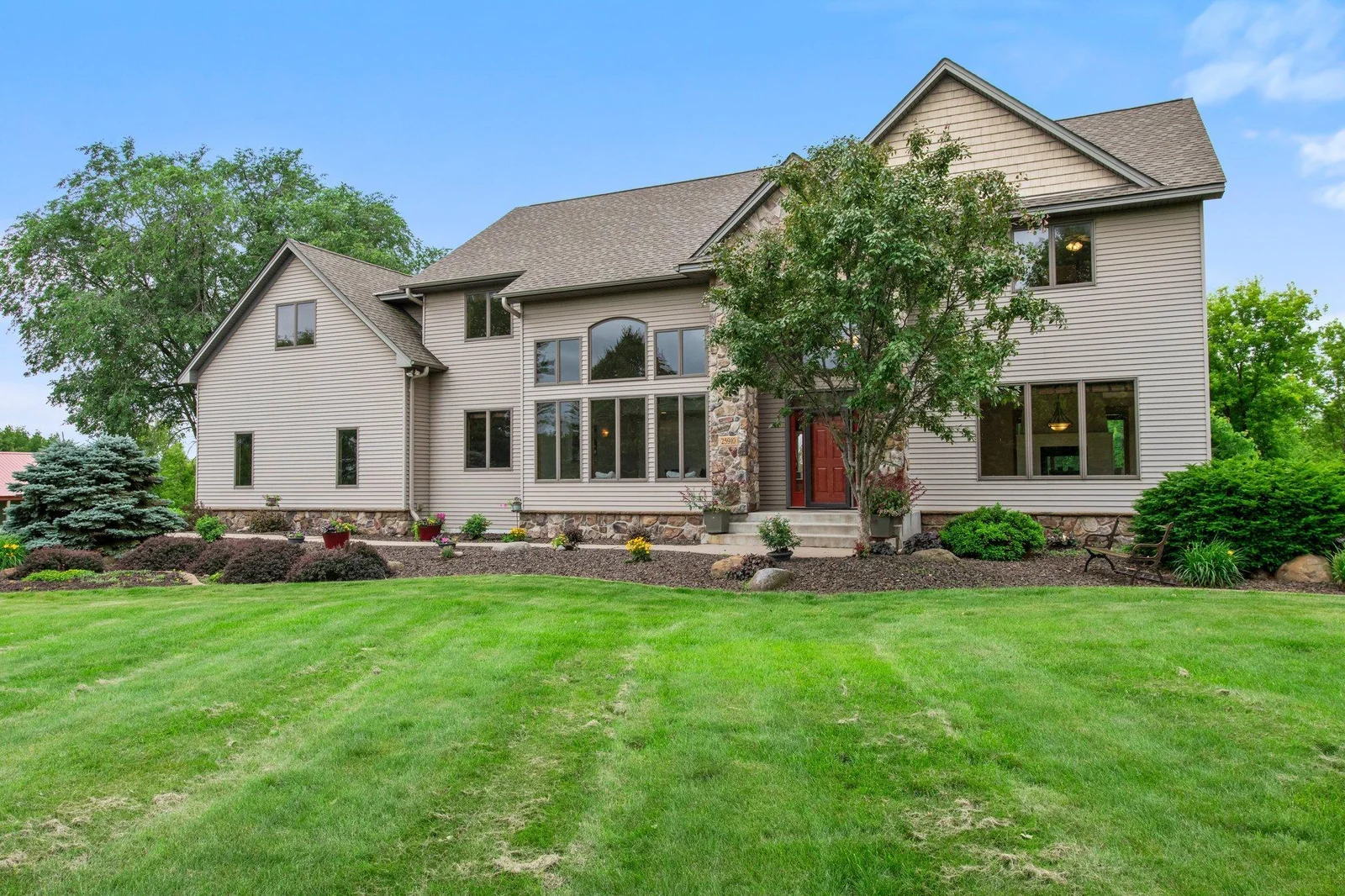 This home features aluminum siding and a stone archway over the front porch.