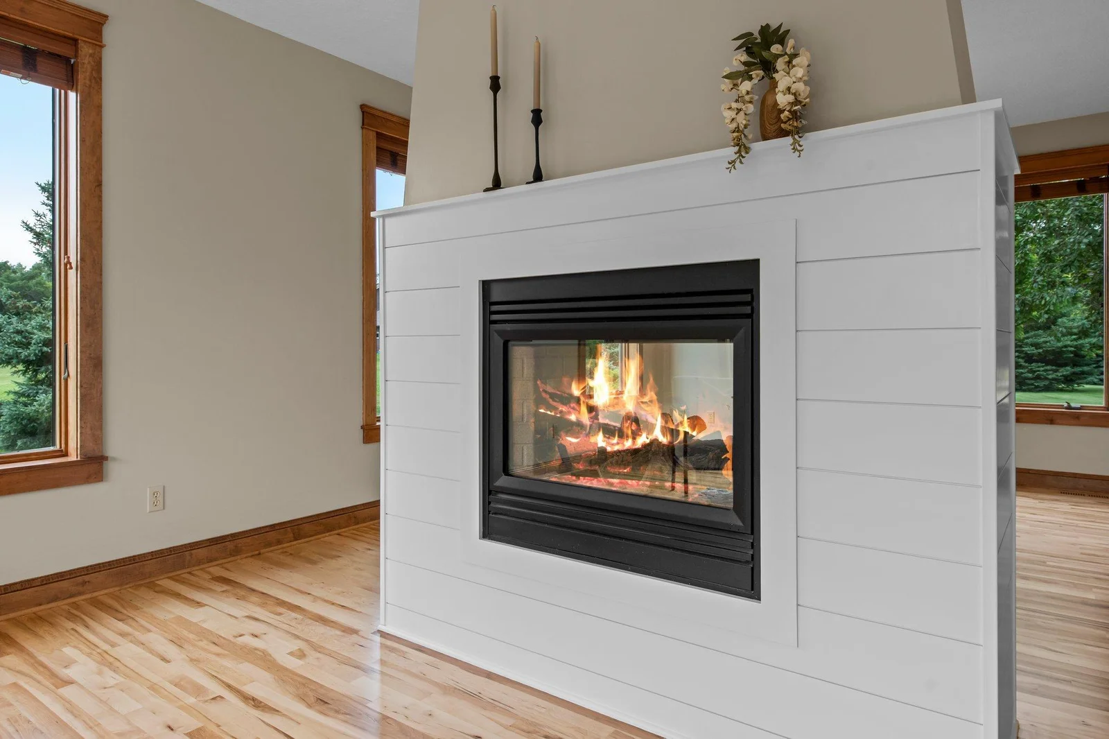 The double sided fireplace is the perfect centerpiece for this home.