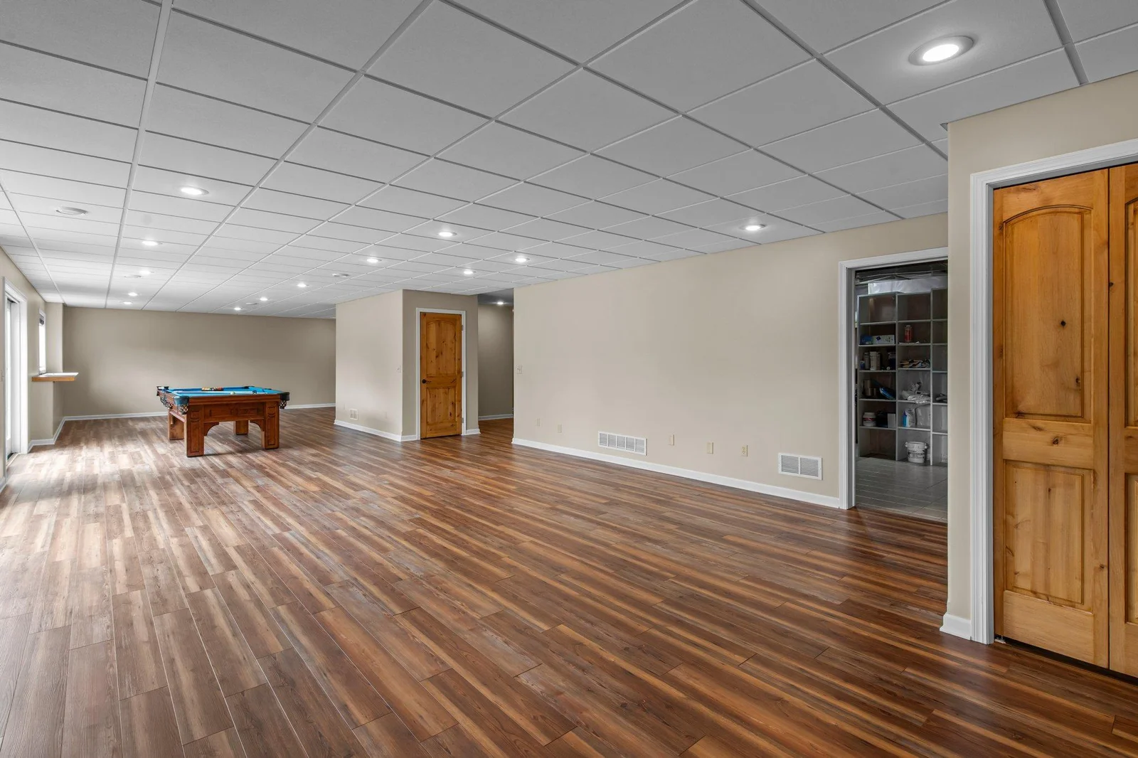 The expansive lower level recreation room includes hardwood floors.