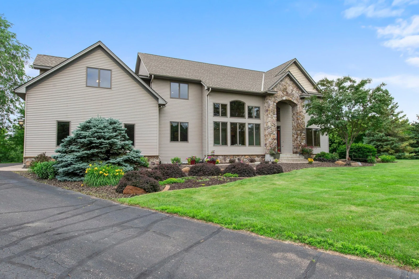 This home features aluminum siding and a stone archway over the front porch.