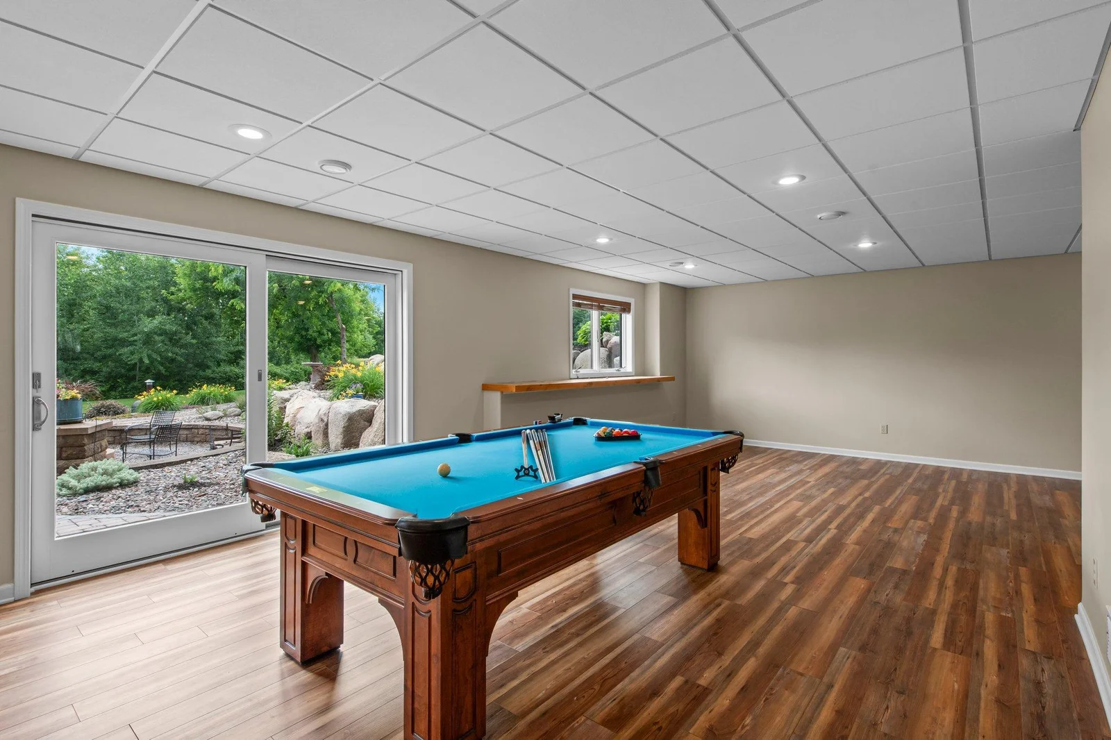 The lower level features a massive recreation room, complete with access to the backyard and pool.